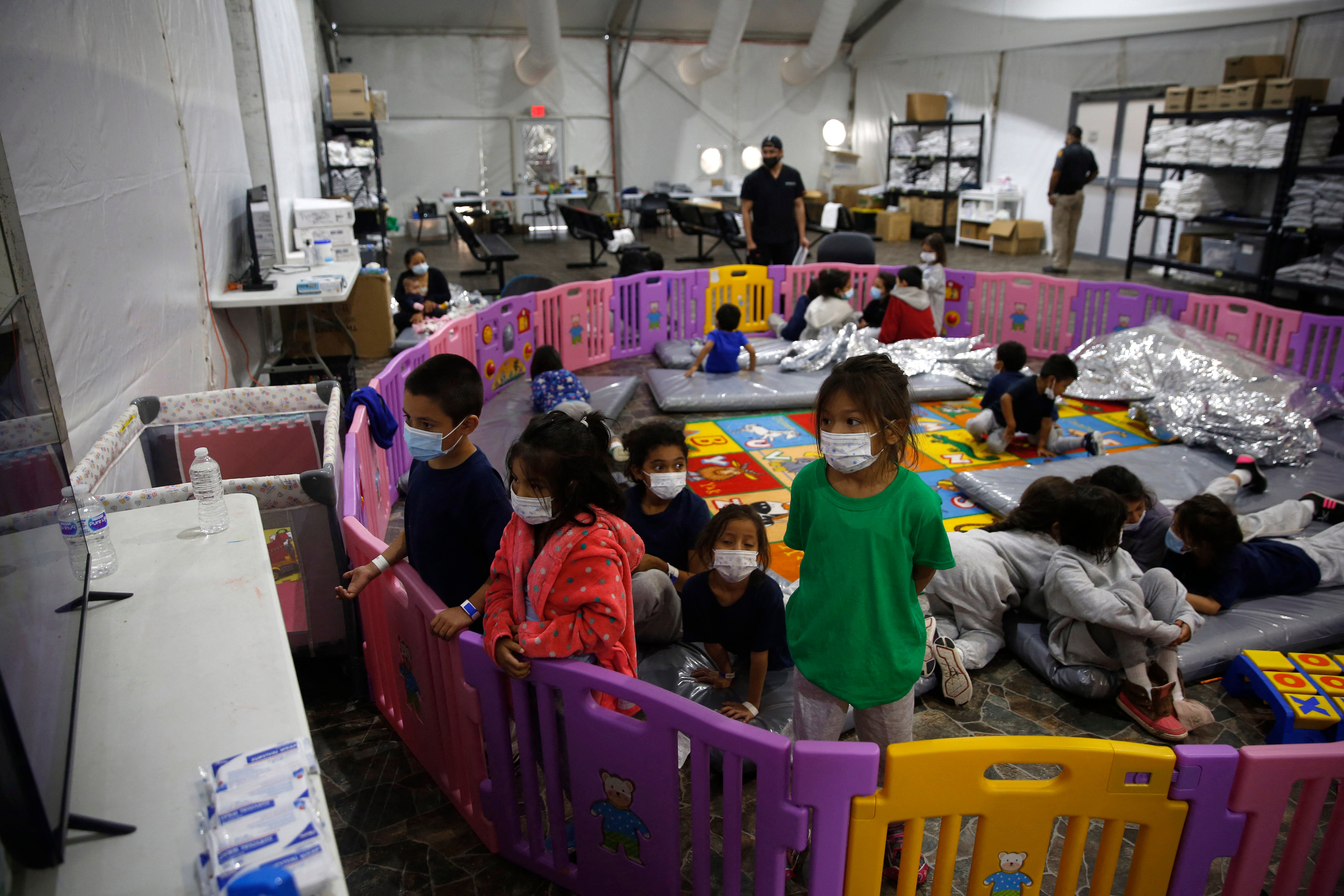 Very youngest migrants sleeping on floor of playpen