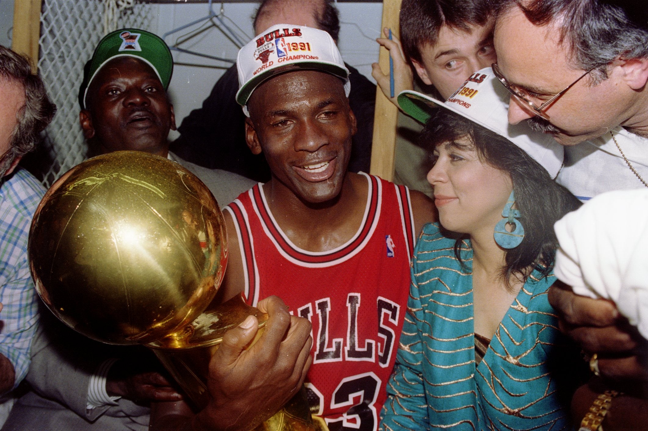 Michael Jordan with wife Juanita and his dad James while holding the NBA Championship Trophy in 1991 at the Great Western Forum in Inglewood, California