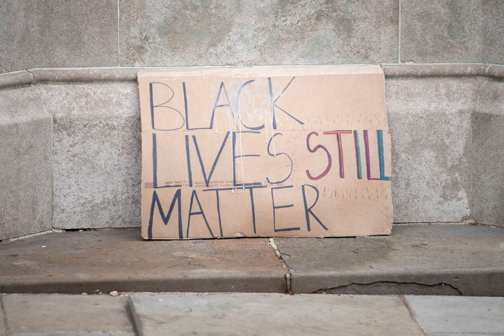 BLM placard placed on the plinth of an Edward Colston statue in Bristol