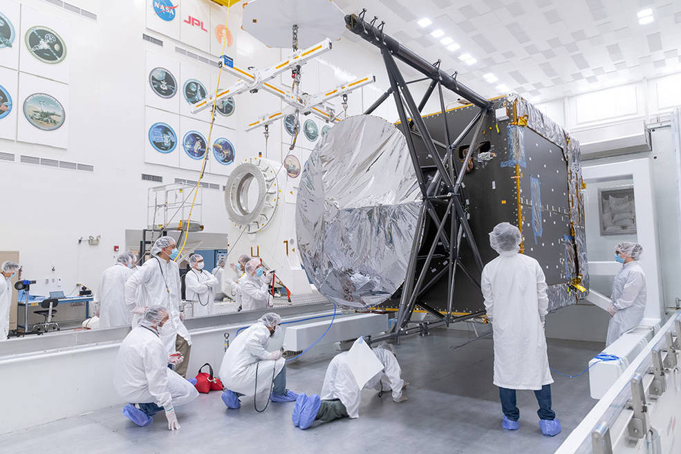 Engineers and technicians prepare to move the chassis of NASA’s Psyche spacecraft from its shipping container to a dolly inside JPL’s Spacecraft Assembly Facility just after the chassis was delivered by Maxar Technologies in late March of 2021.