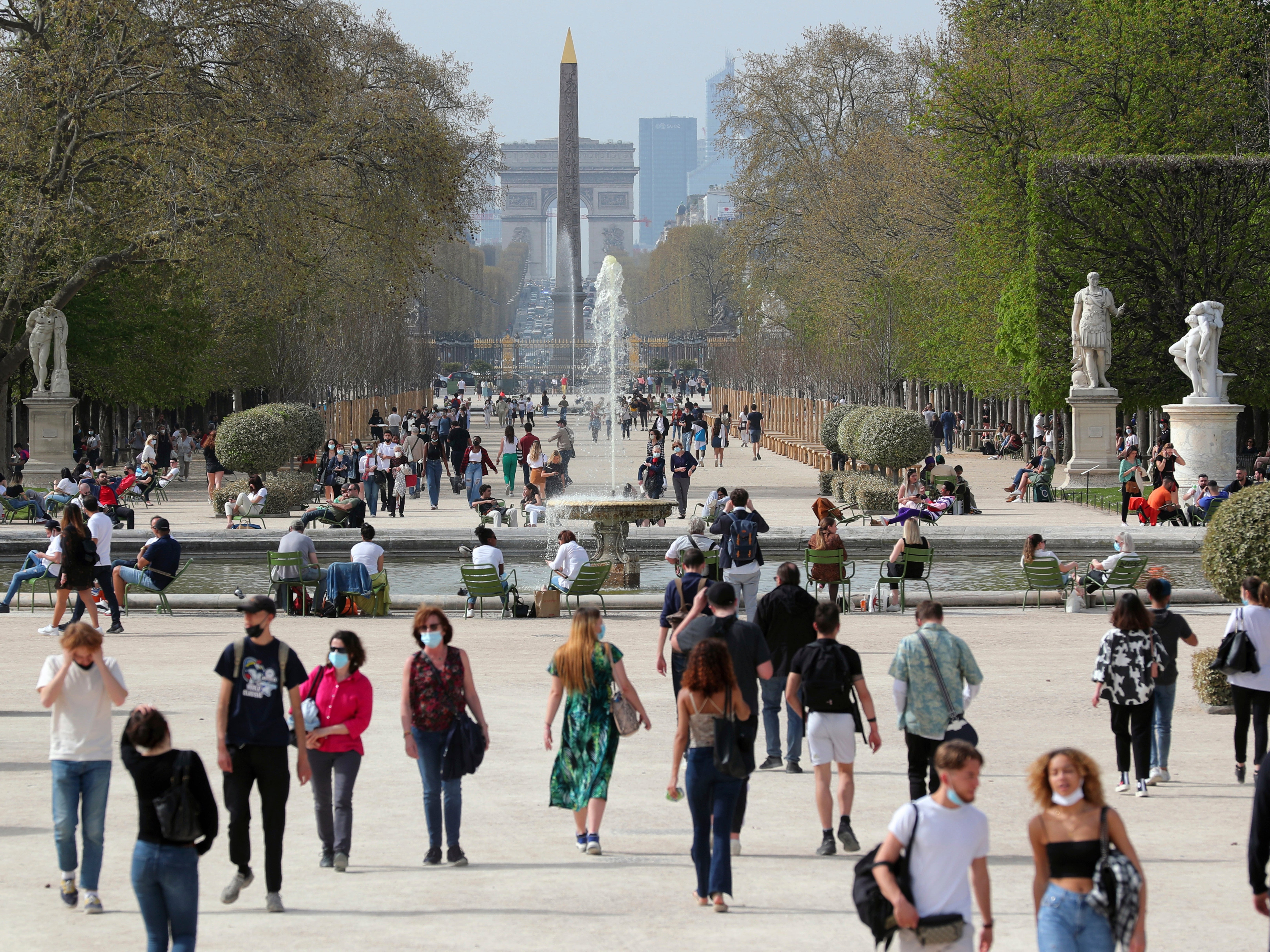 People wear face mask as they walk in the Tuileries garden in Paris, 1 April