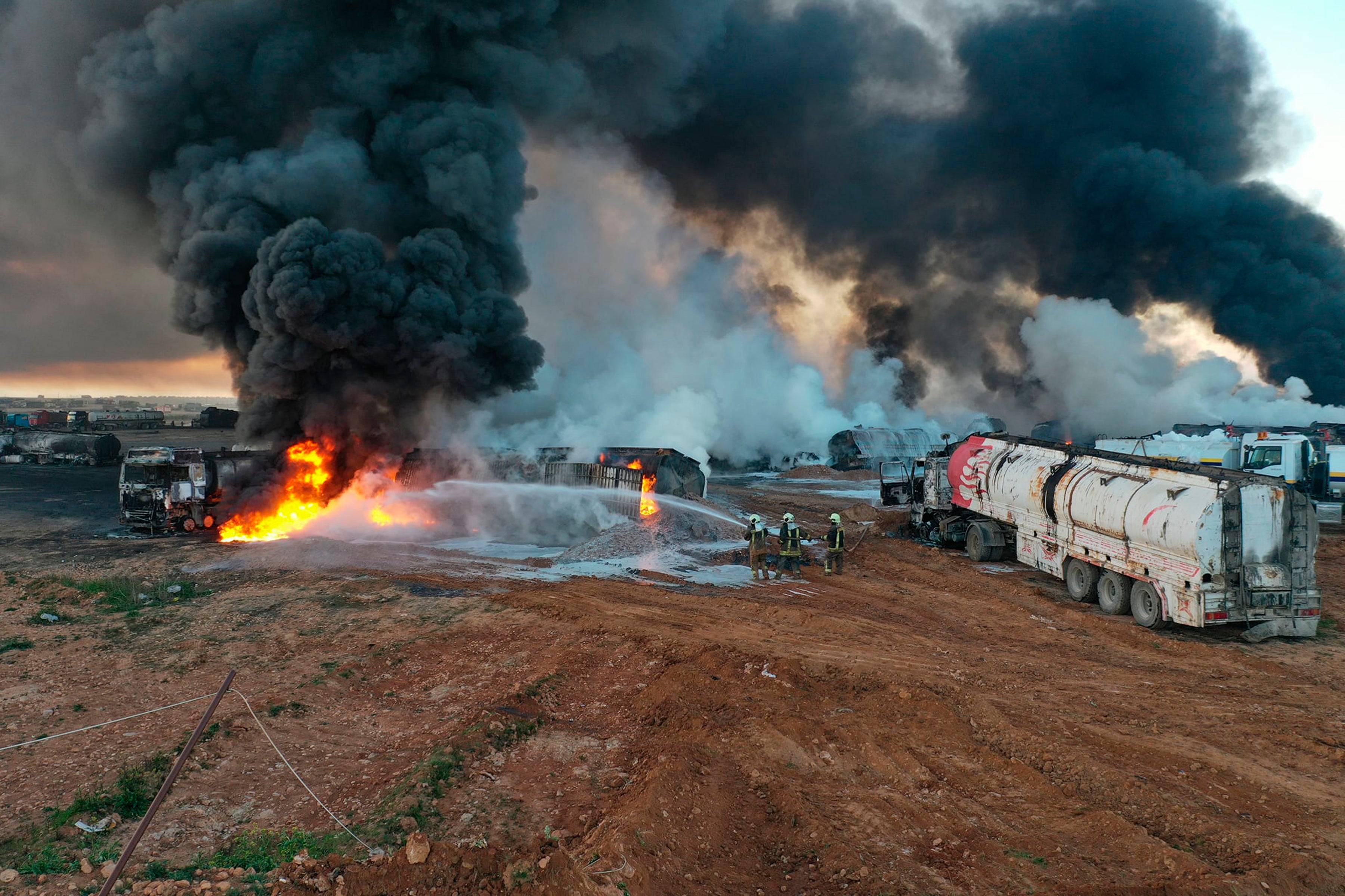 Civil defence workers extinguish burning oil tanker trucks after a suspected missile strike around the towns of Jarablus and al-Bab last month. Syrian opposition groups blamed Russia for the strikes