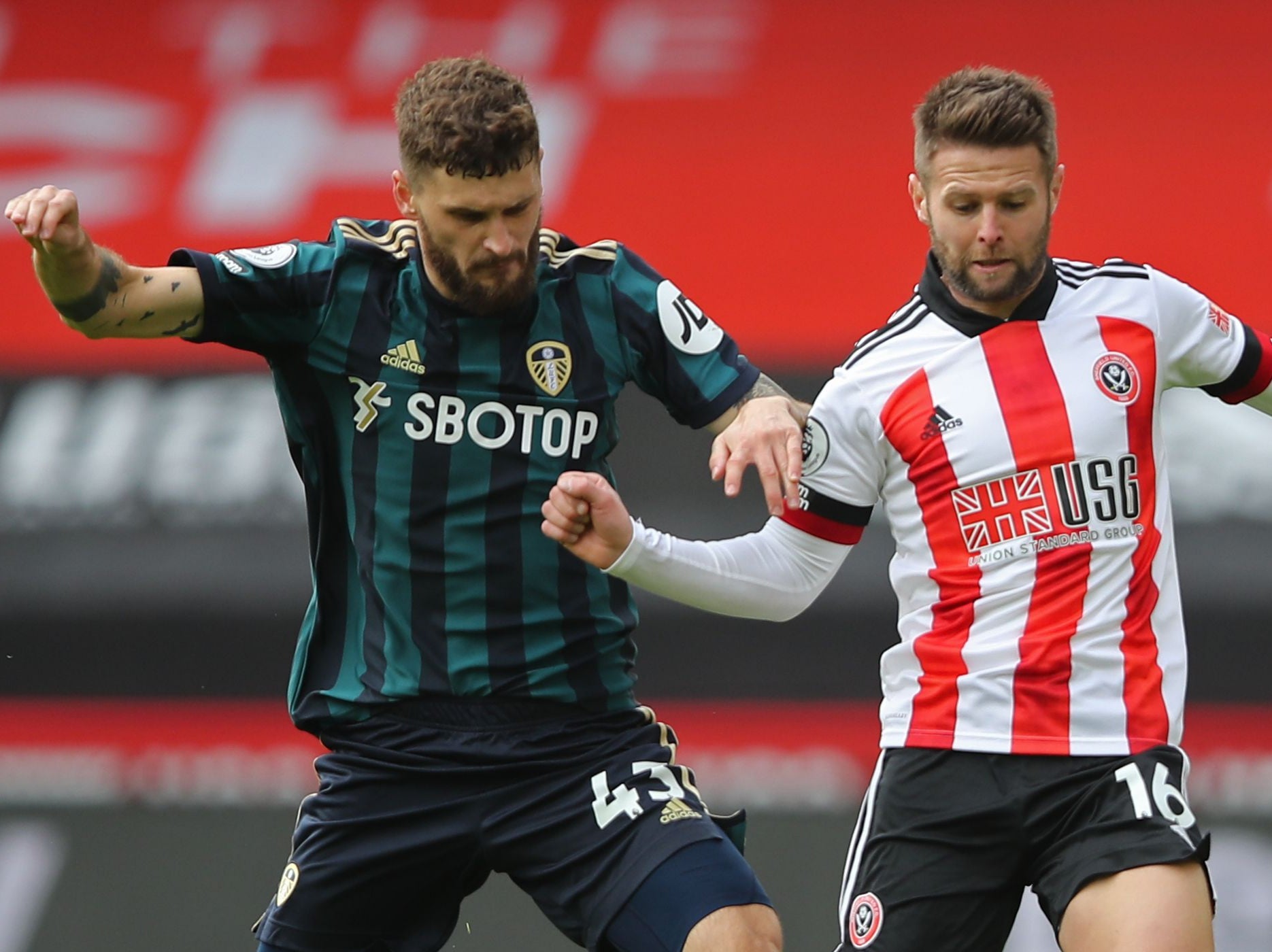 Leeds’ Mateusz Klich (left) challenges Sheffield United’s Oliver Norwood