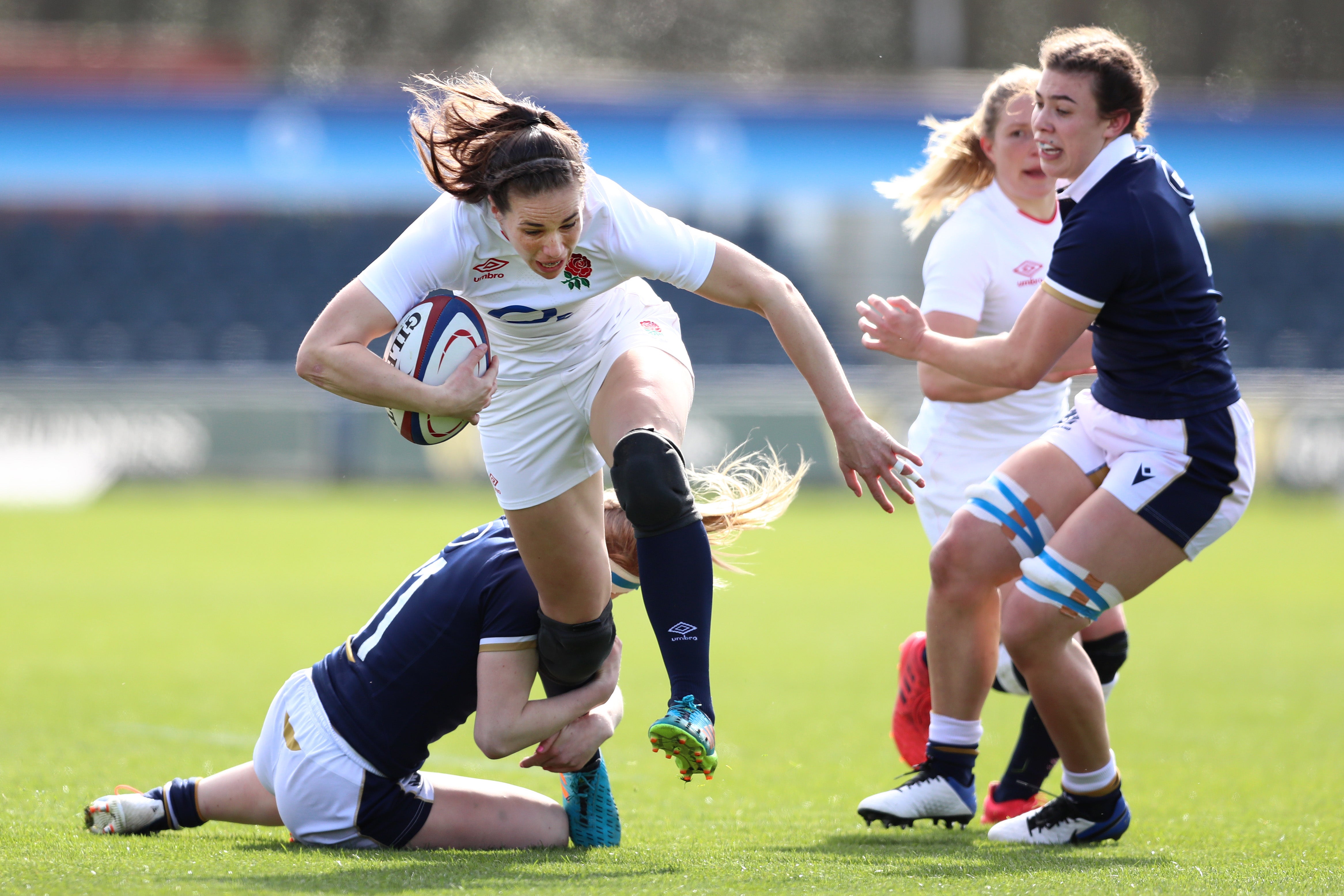 Emily Scarratt of England is tackled by Megan Gaffney of Scotland