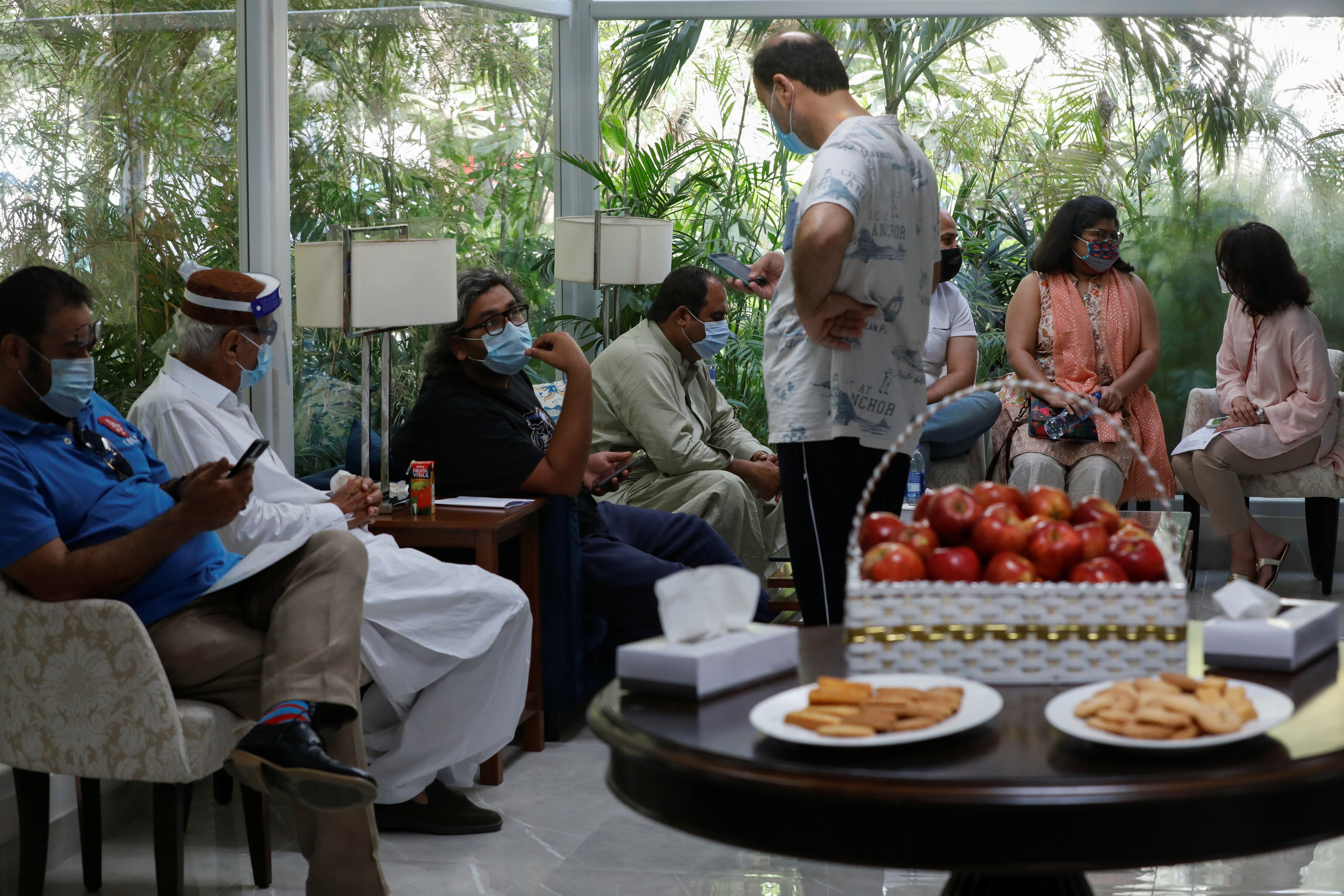 Residents wait for a commercial dose of Russia’s Sputnik V vaccine at a private hospital in Karachi