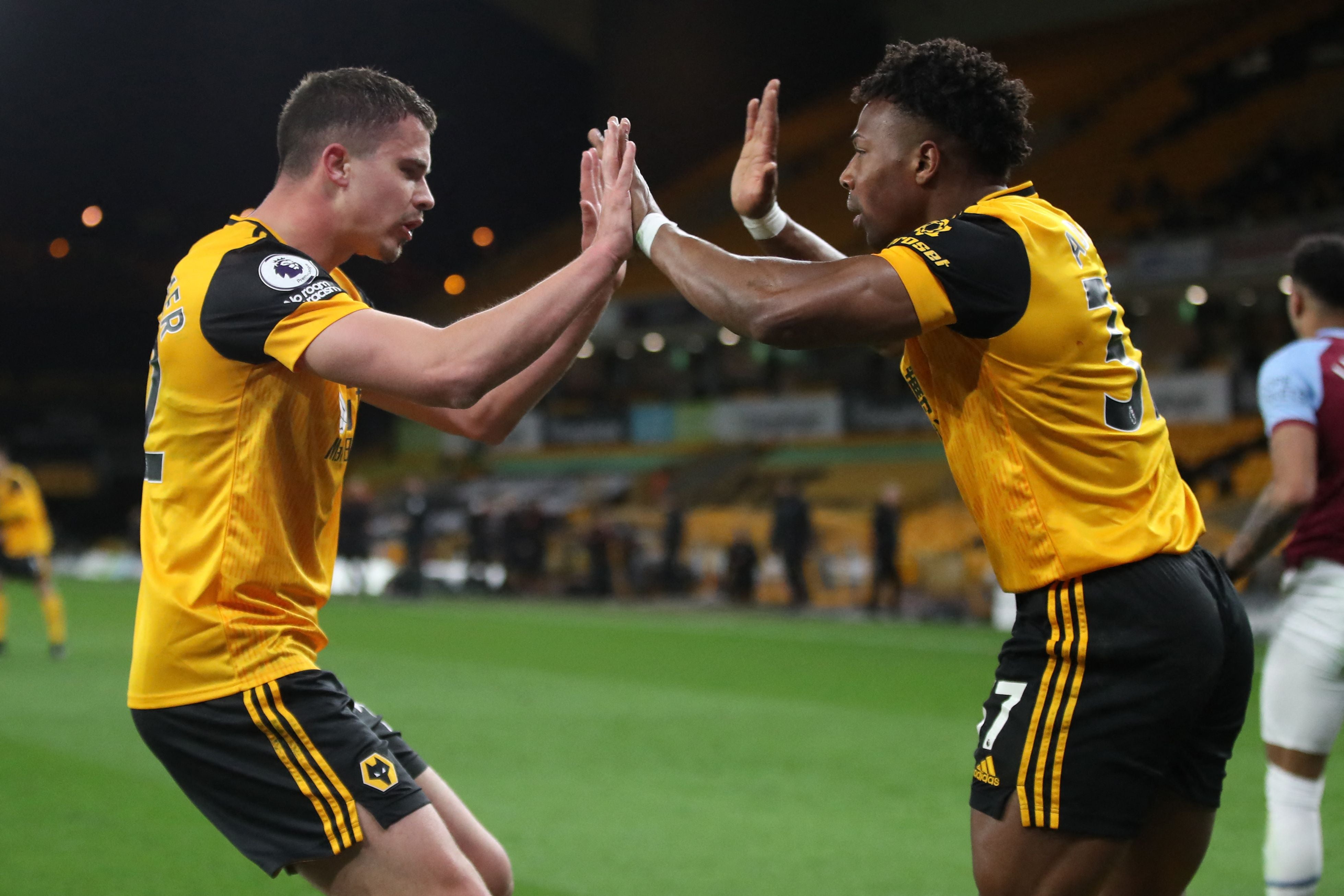 Leander Dendoncker celebrates with Adama Traore after Wolves pulled a goal back