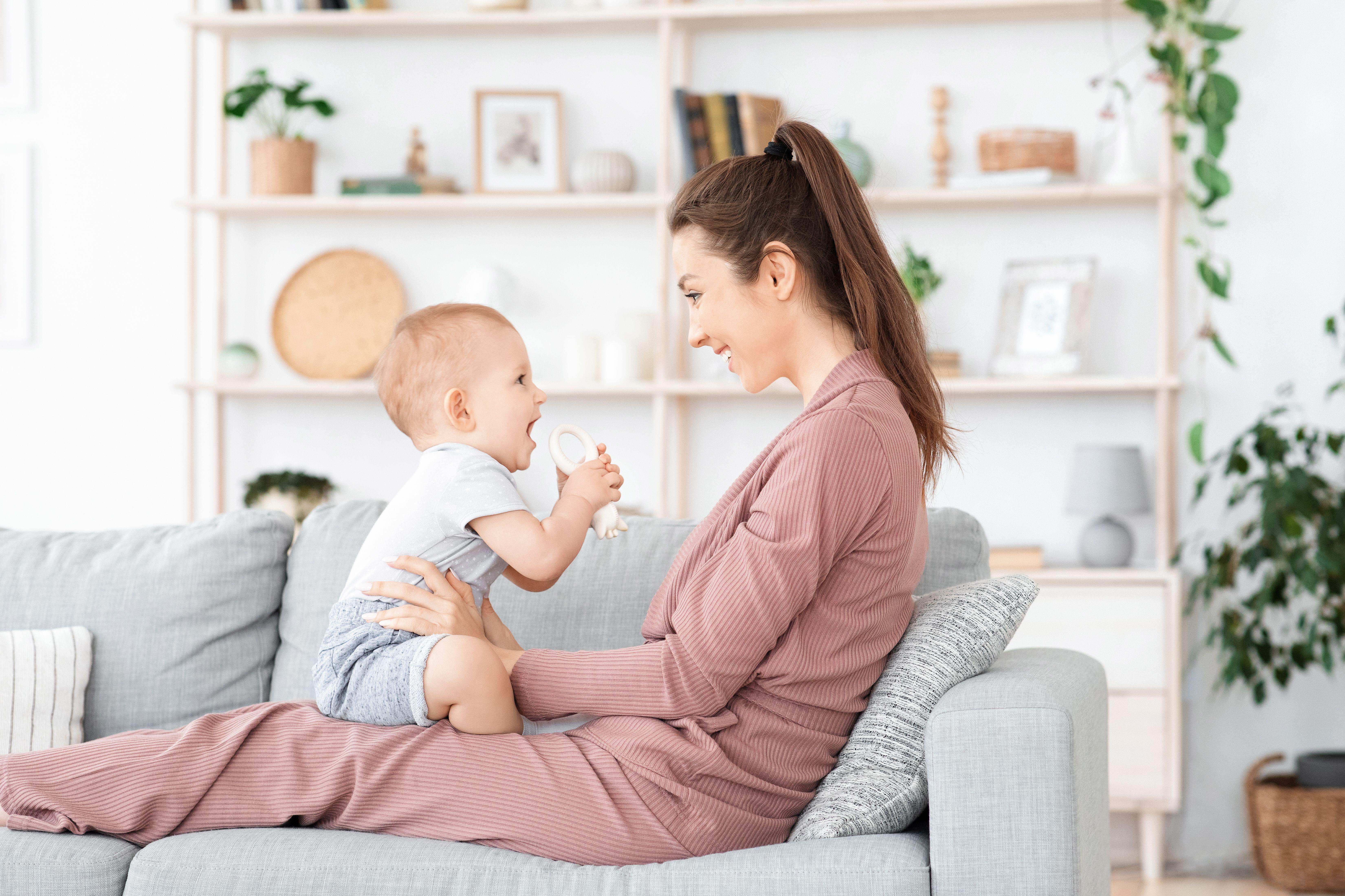 Mum and baby laughing on sofa