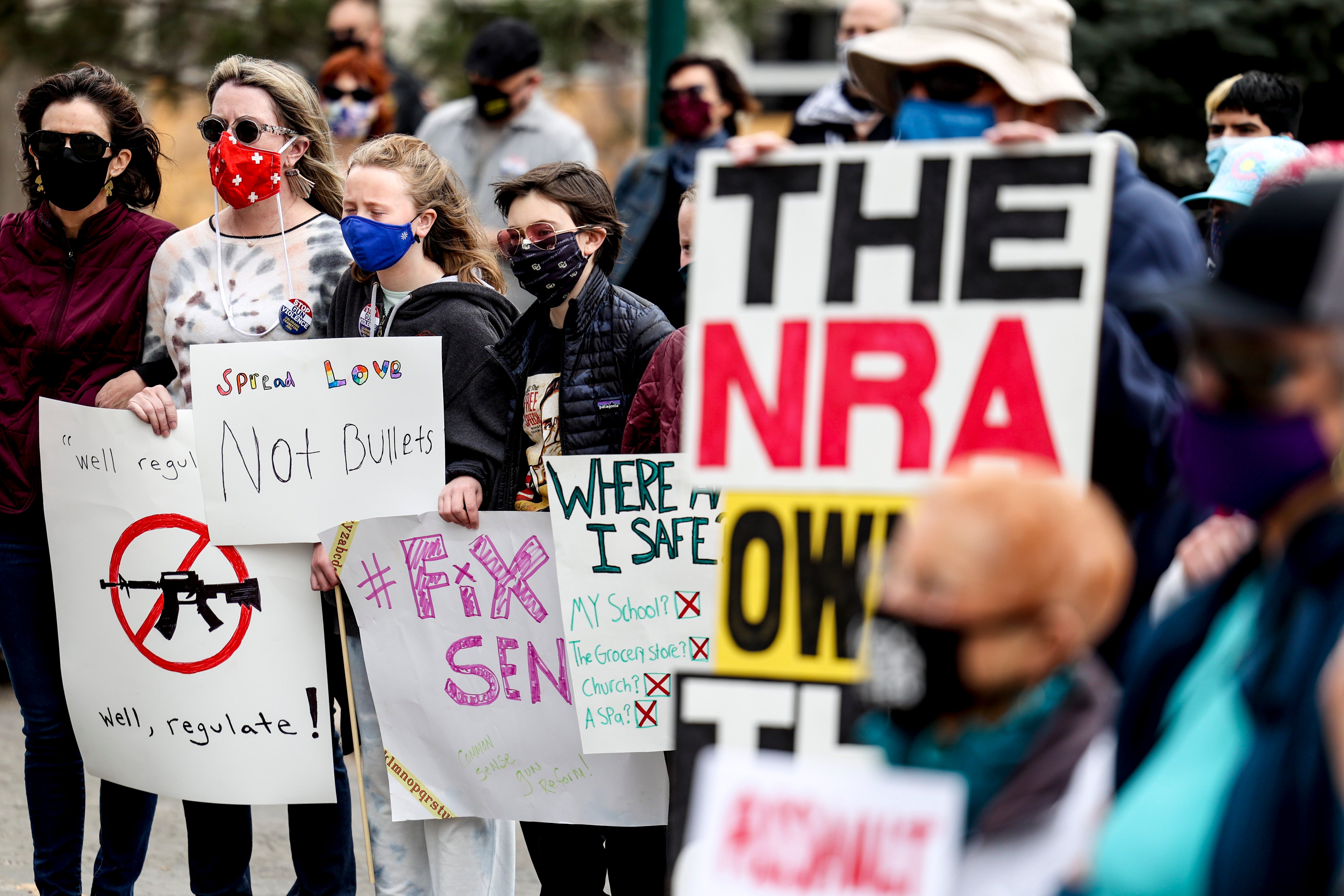 File image: People link arms at a gun reform rally at the Colorado State Capitol on 28 March, 2021 in Denver, Colorado