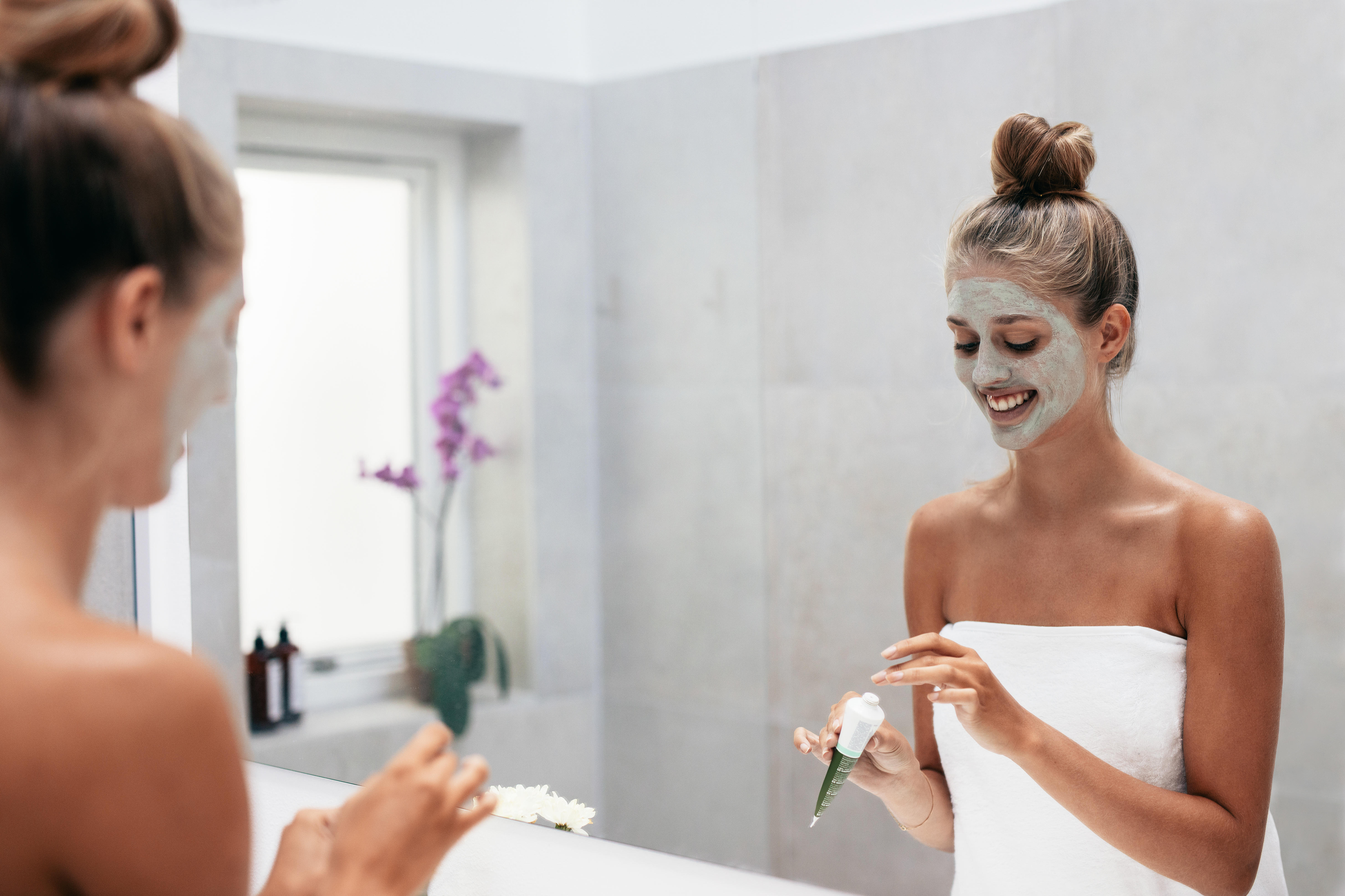 woman applying facemask