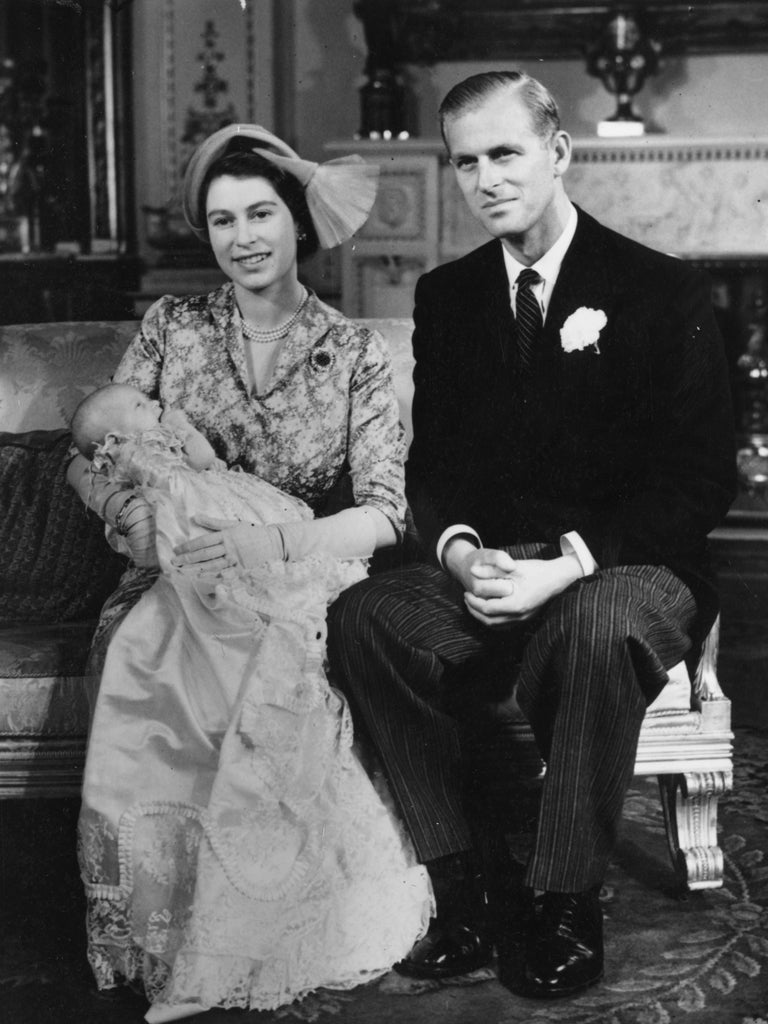 21 October 1950: Princess Elizabeth holding her daughter Princess Anne at her christening in Buckingham Palace, with the Duke of Edinburgh at her side