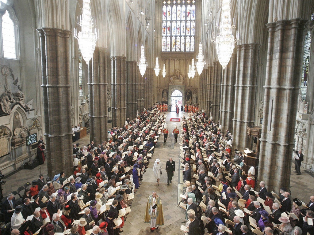 Queen Elizabeth II and Prince Philip walk down the aisle in Westminster Abbey, in London, 19 November 2007, to attend a service to celebrate their diamond wedding anniversary