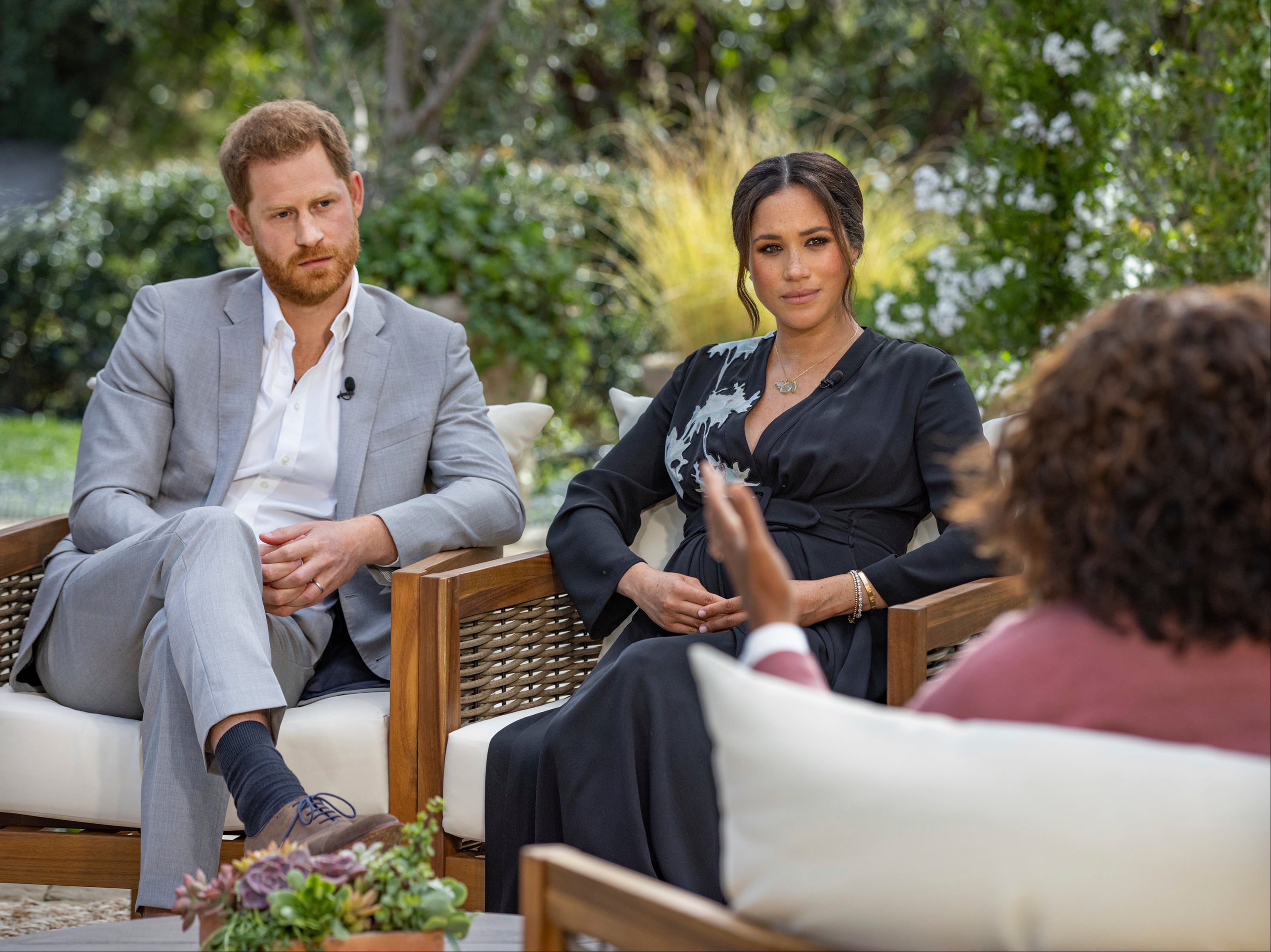 This image provided by Harpo Productions shows Prince Harry, from left, and Meghan, Duchess of Sussex, in conversation with Oprah Winfrey. Almost as soon as the interview aired, many were quick to deny Meghan’s allegations of racism on social media