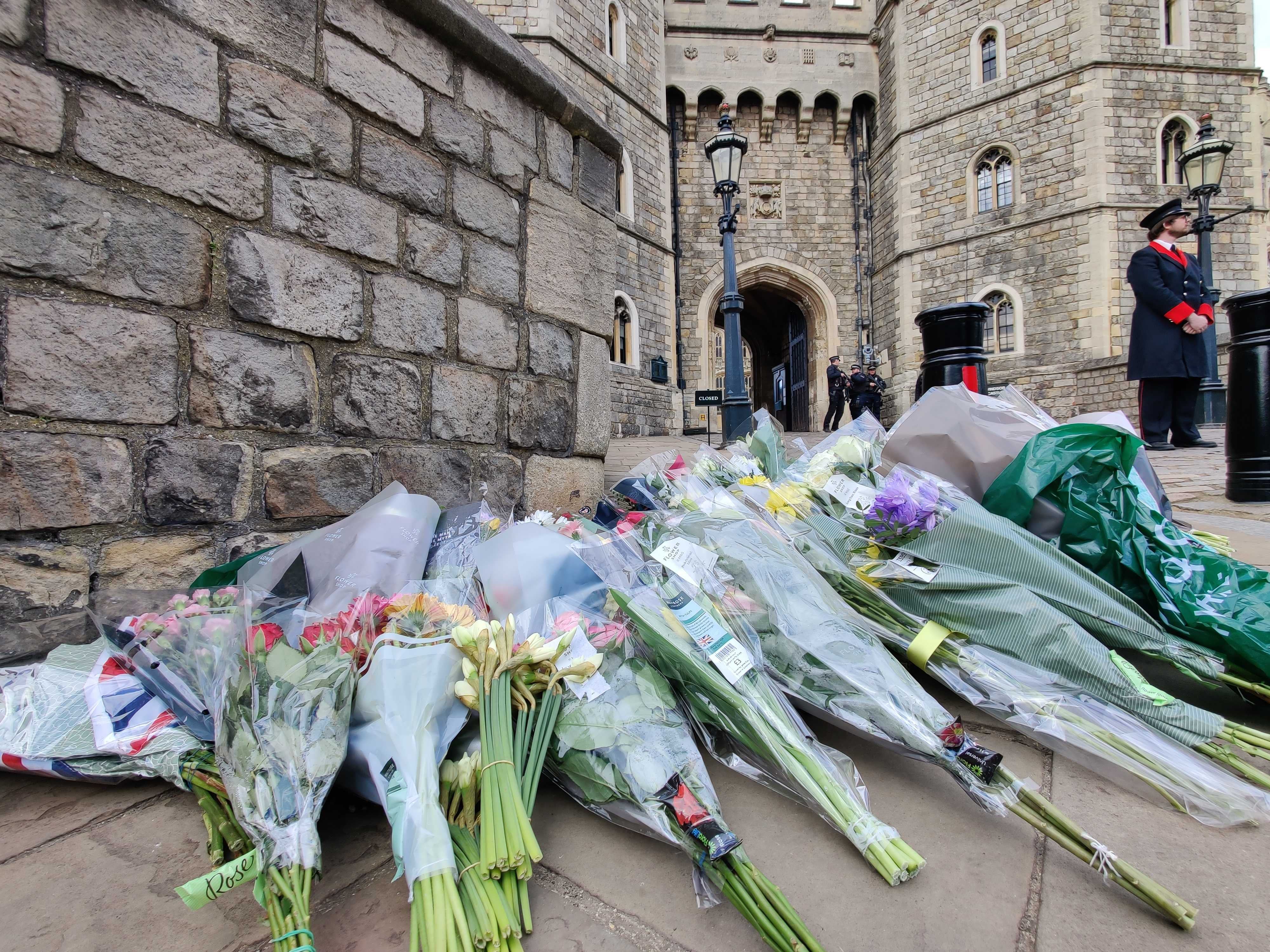 Flowers are pictured outside Windsor Castle after the death of Prince Philip was announced on 9 April, 2021.