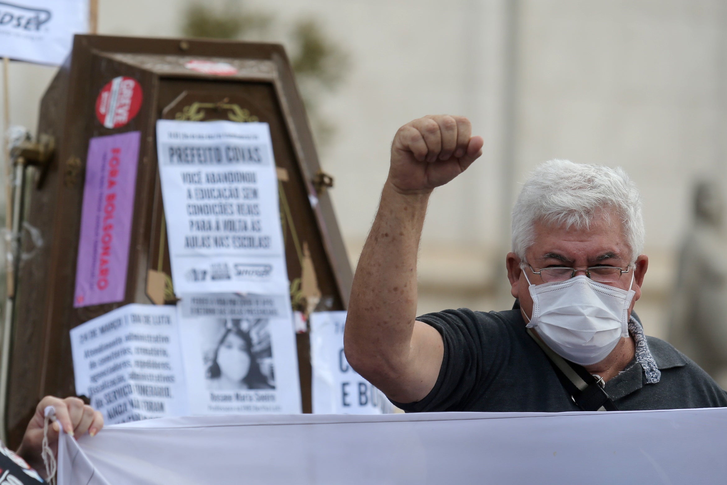 A man gestures as he takes part in a protest against Sao Paulo's mayor Bruno Covas, the state’s governor Joao Doria and Bolsonaro for their mismanagement of Covid-19