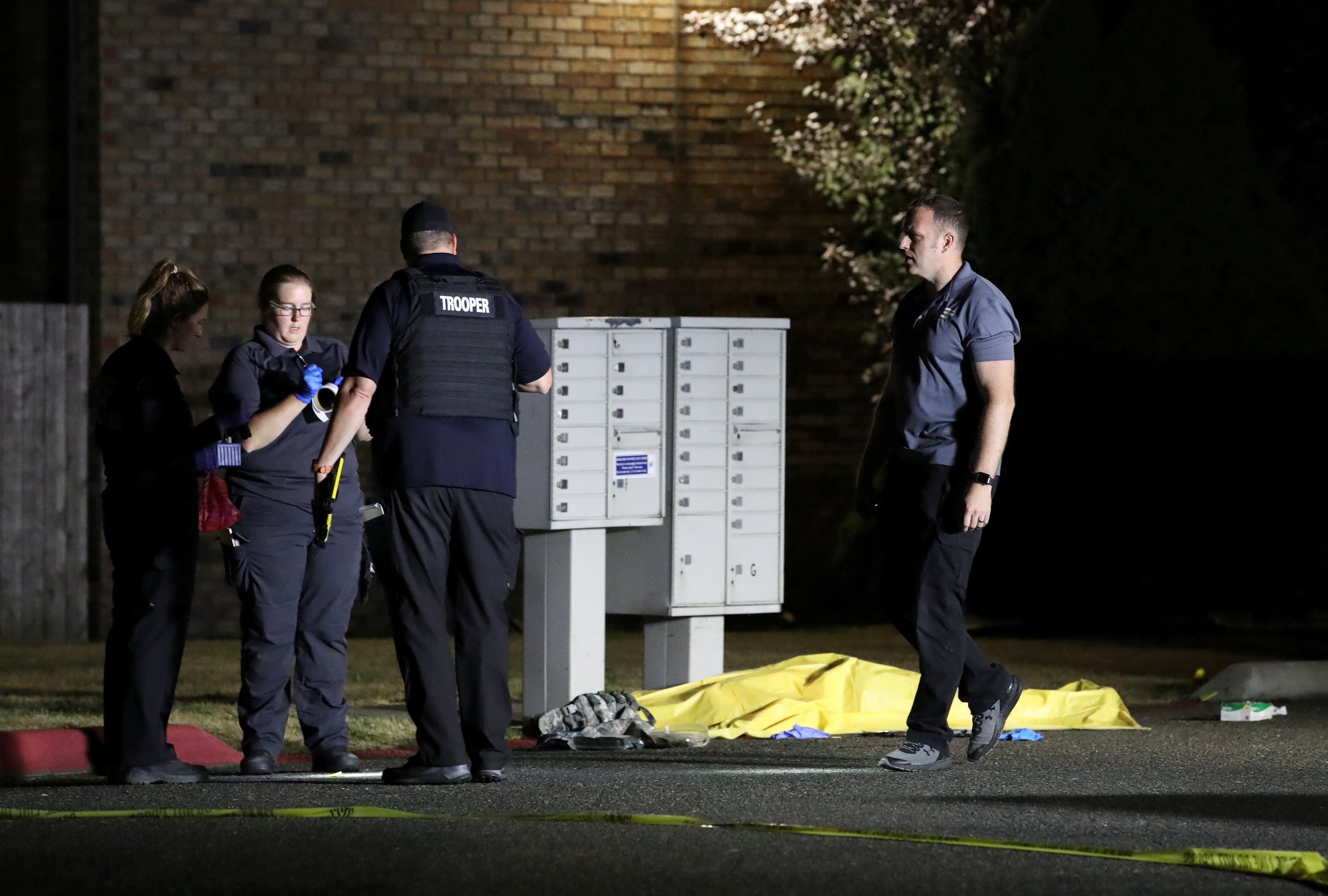 Investigators with the Washington State Crime Lab are seen at Tanglewilde Terrace, where law enforcement officers shot a man reported to be Michael Forest Reinoehl