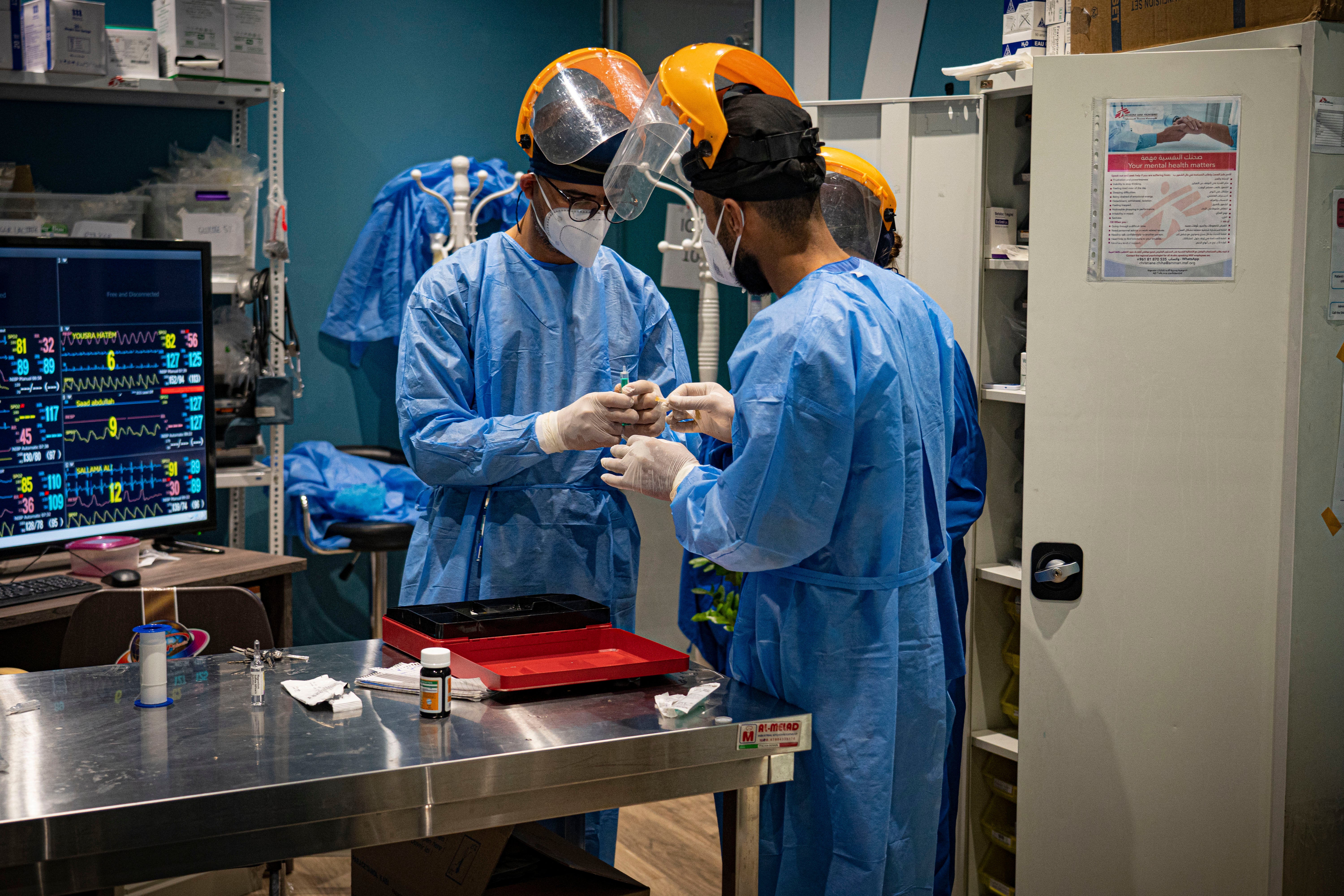 MSF medics rush to help open the airways of an asthmatic Covid-19 patient in their clinic in Baghdad