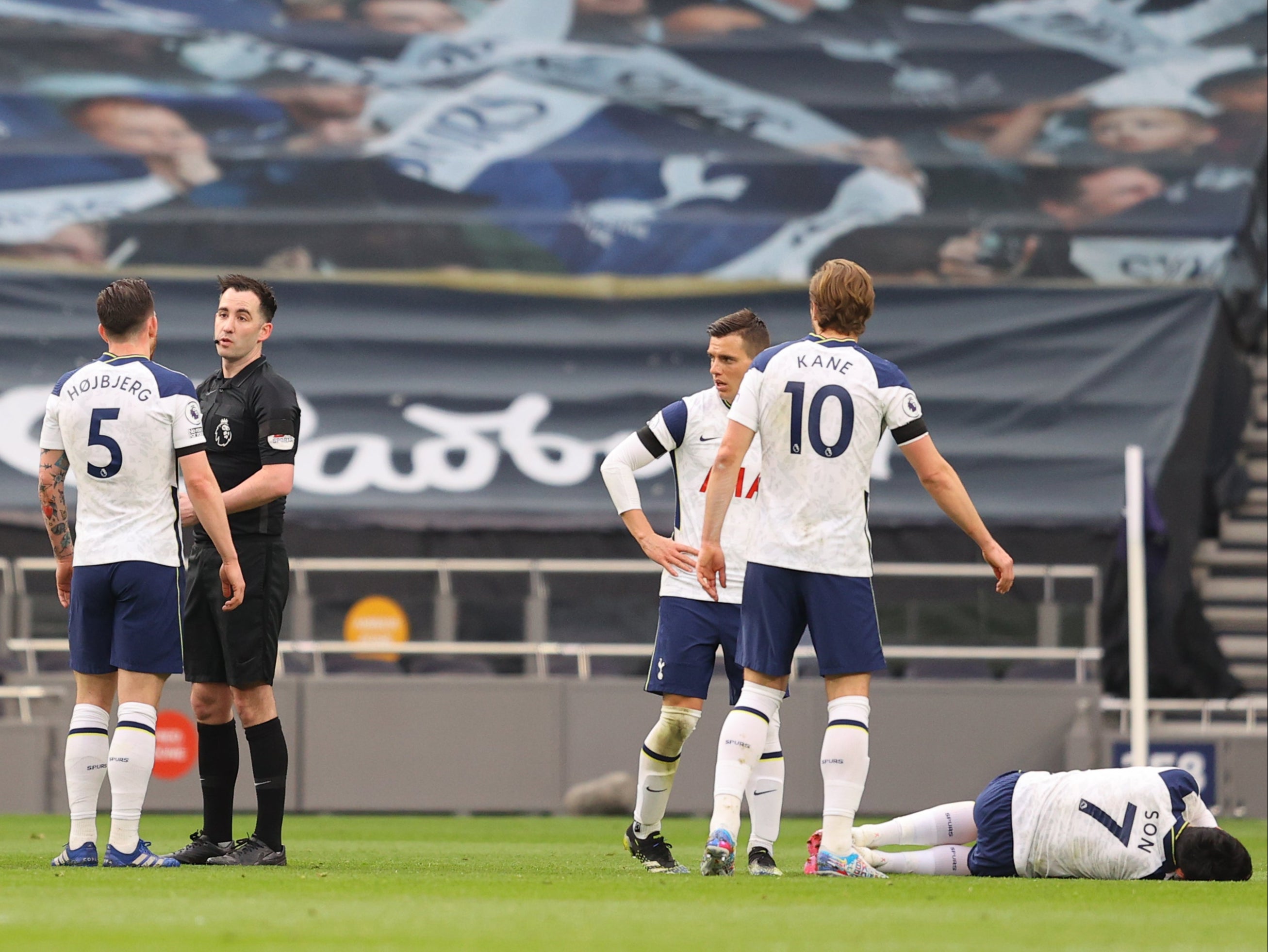 Son Heung-min lies injured after a clash with Scott McTominay