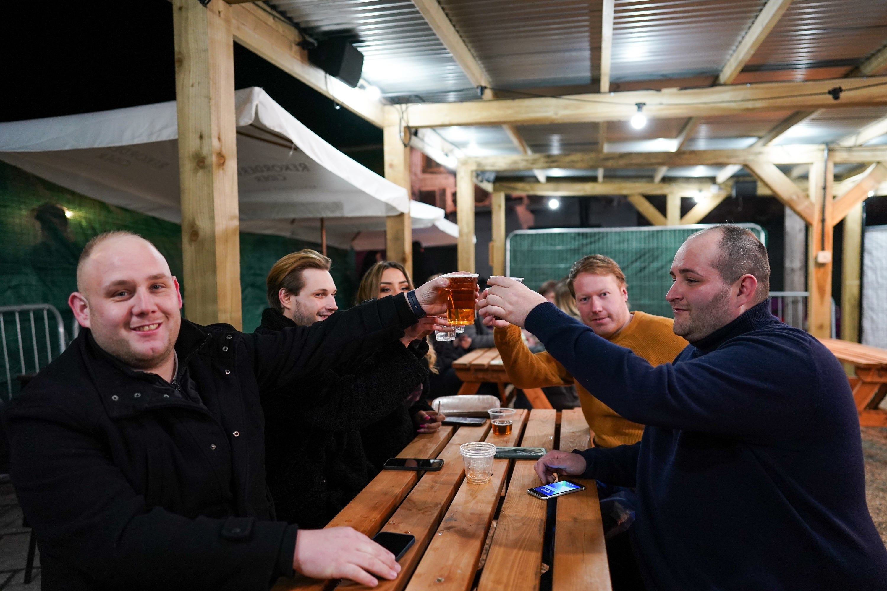 Customers toast as they enjoy a drink at the Switch bar in Newcastle shortly after midnight following the easing of lockdown measures