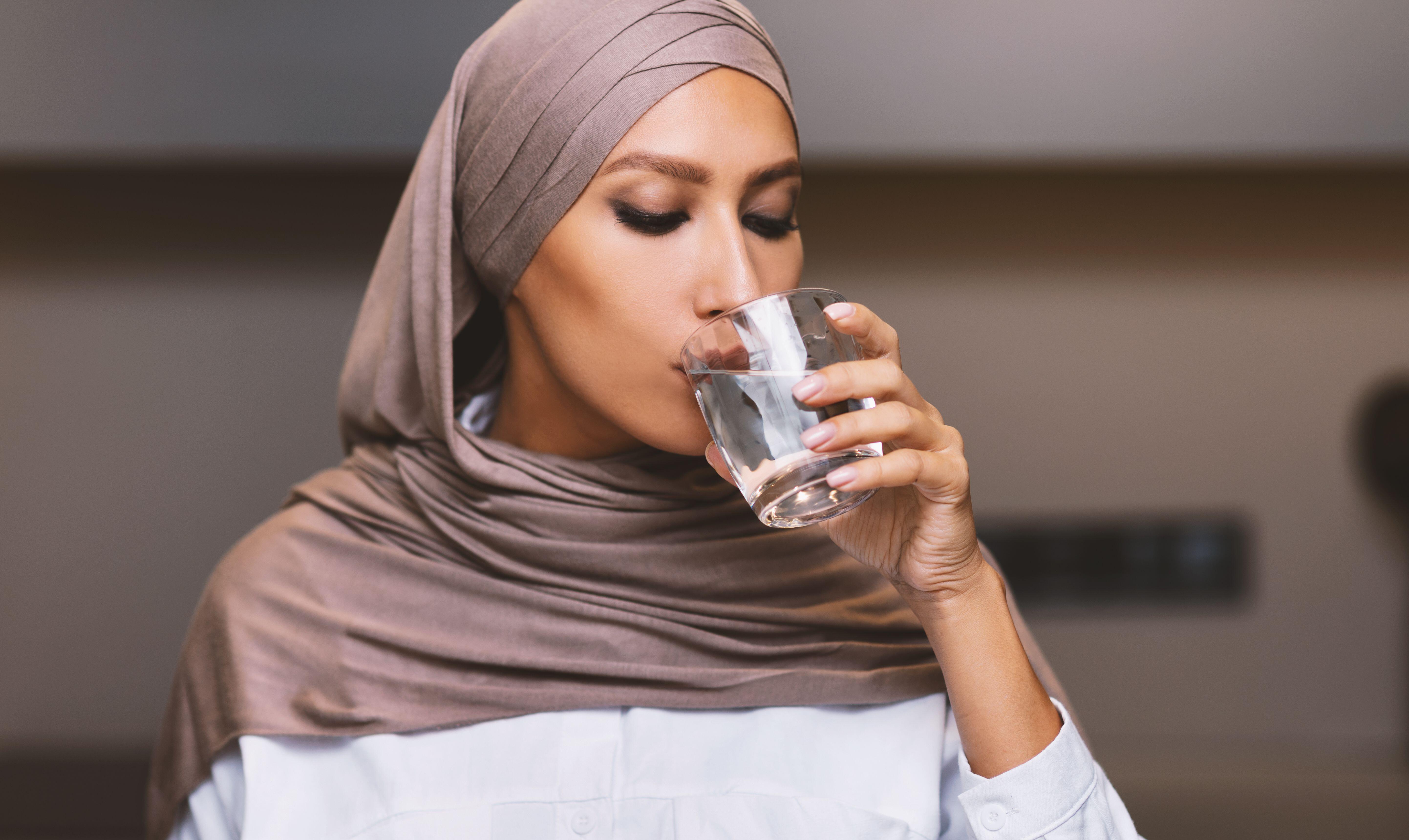 Muslim Woman Drinking Water