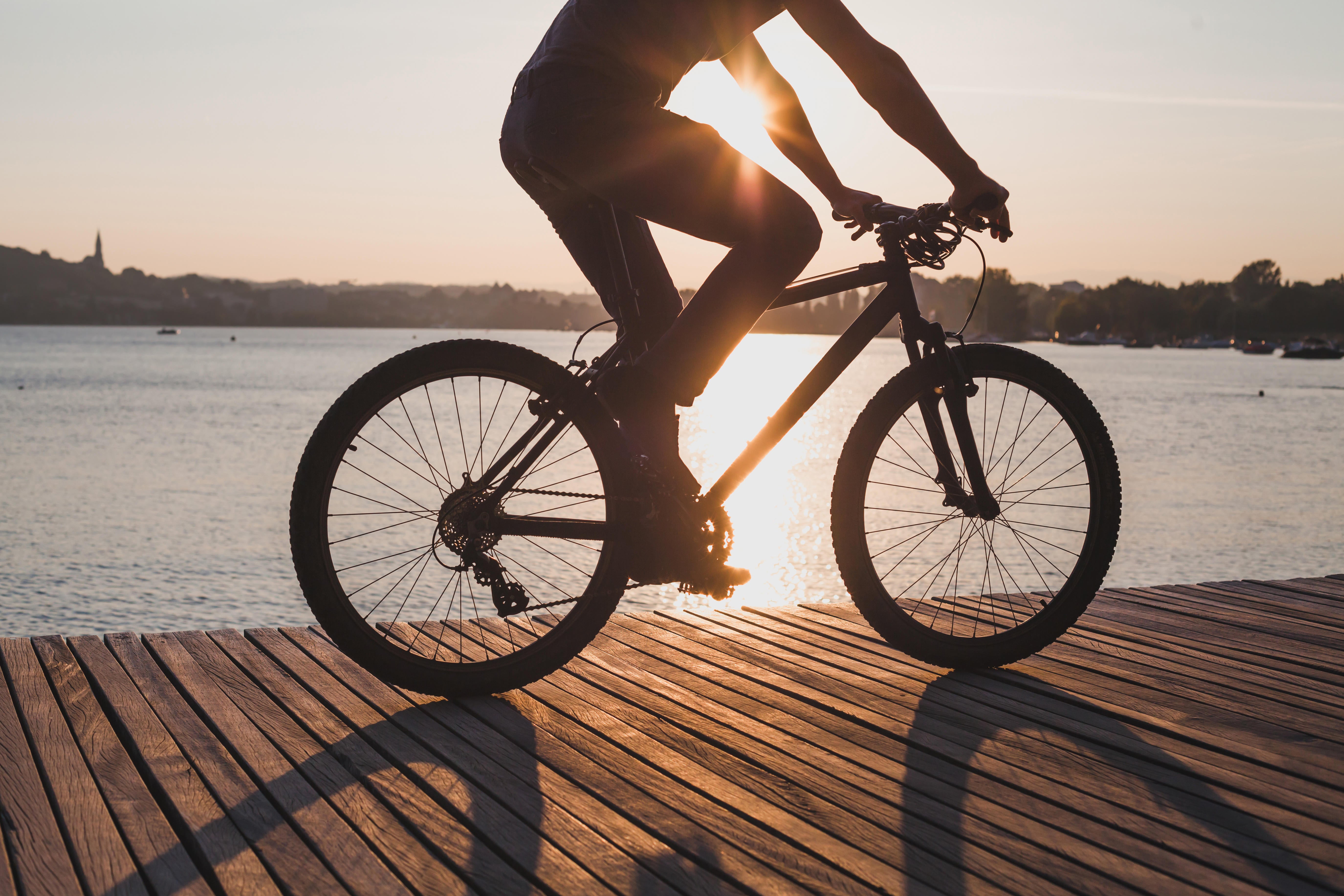 man riding bicycle at sunset