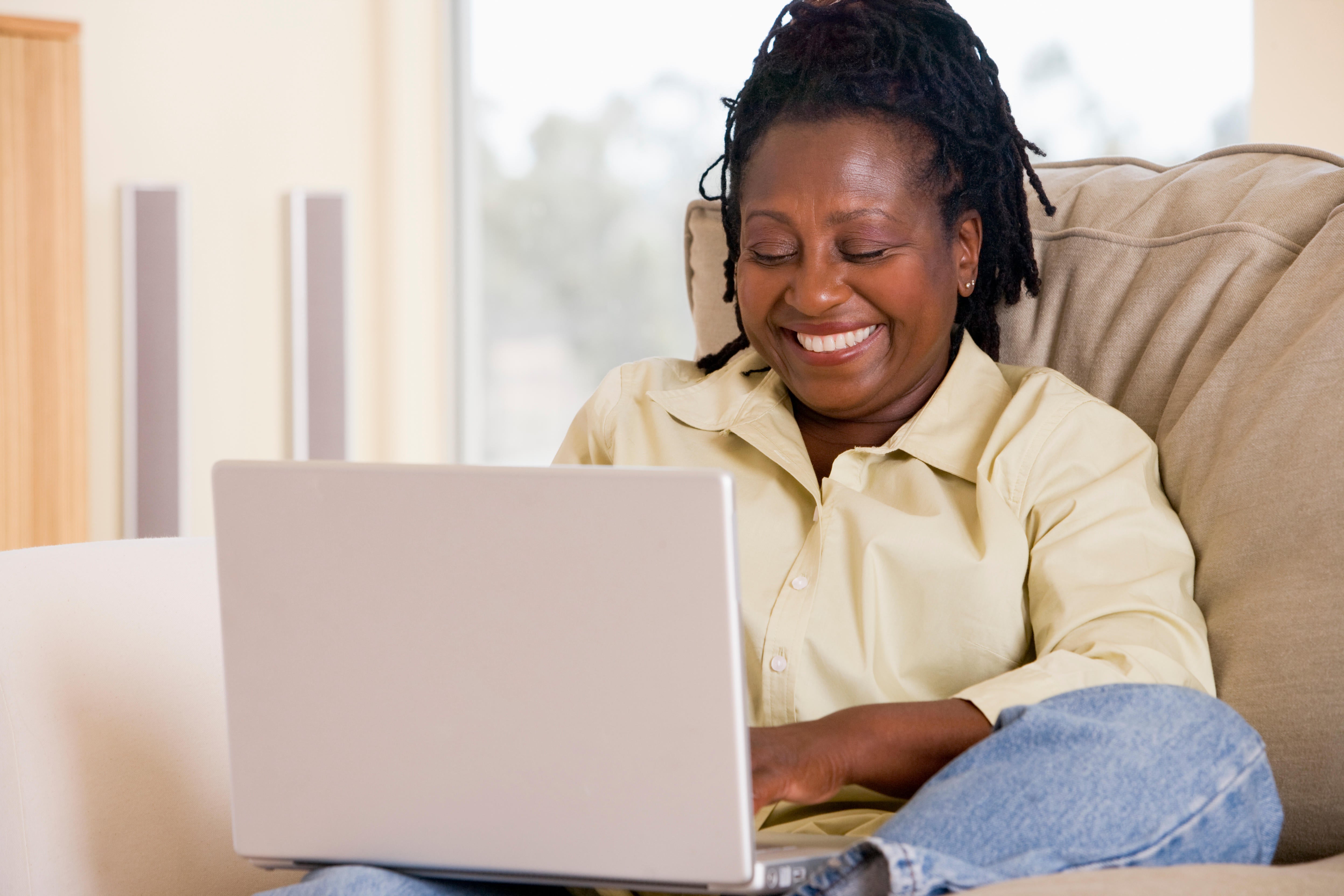 woman sat at home using a laptop