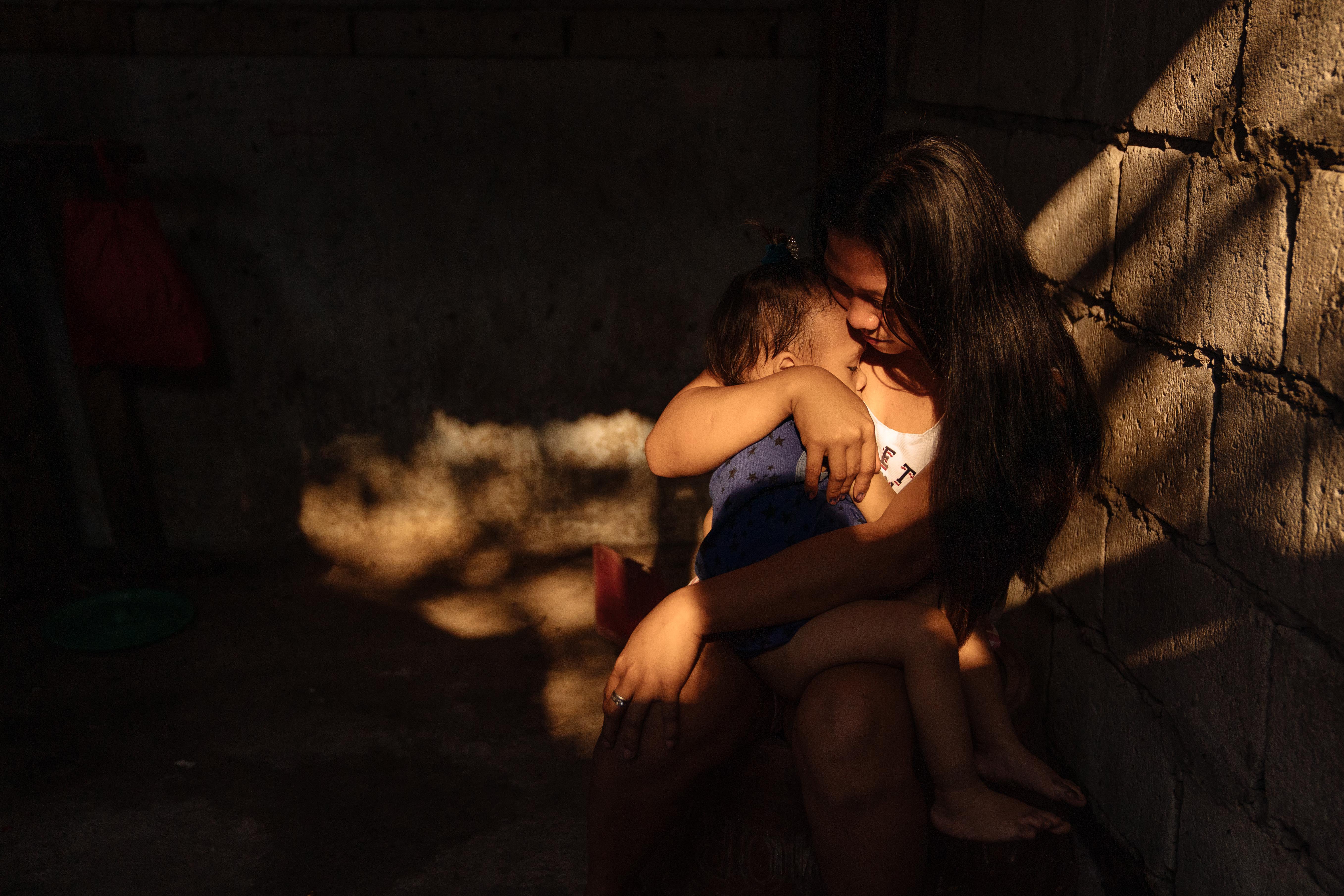 Rosemarie Santiago at home with her son Jericho, who was born while she was incarcerated in Manila