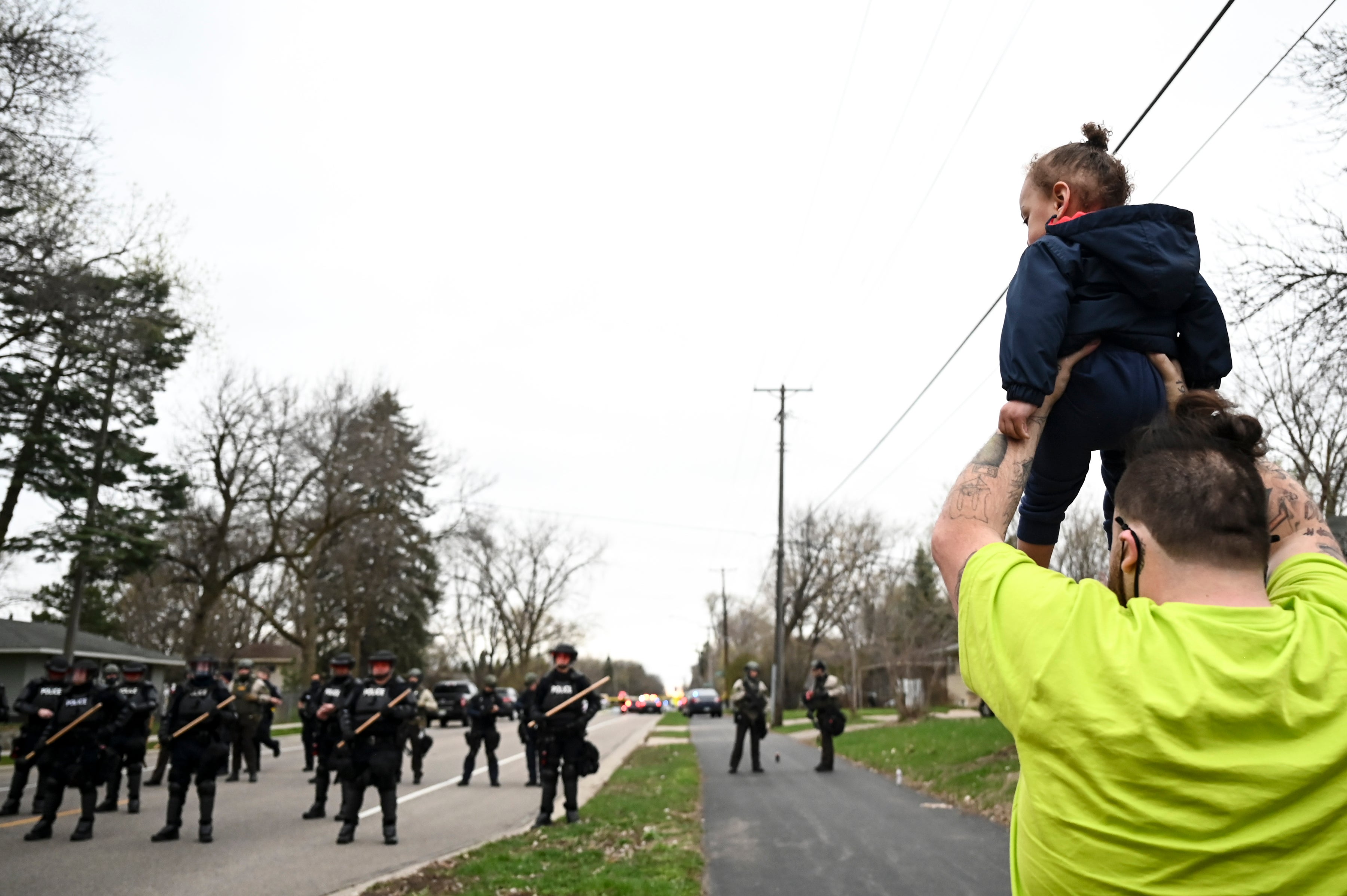 Damik Wright, brother of Daunte Wright, holds Daunte’s son during Sunday protest