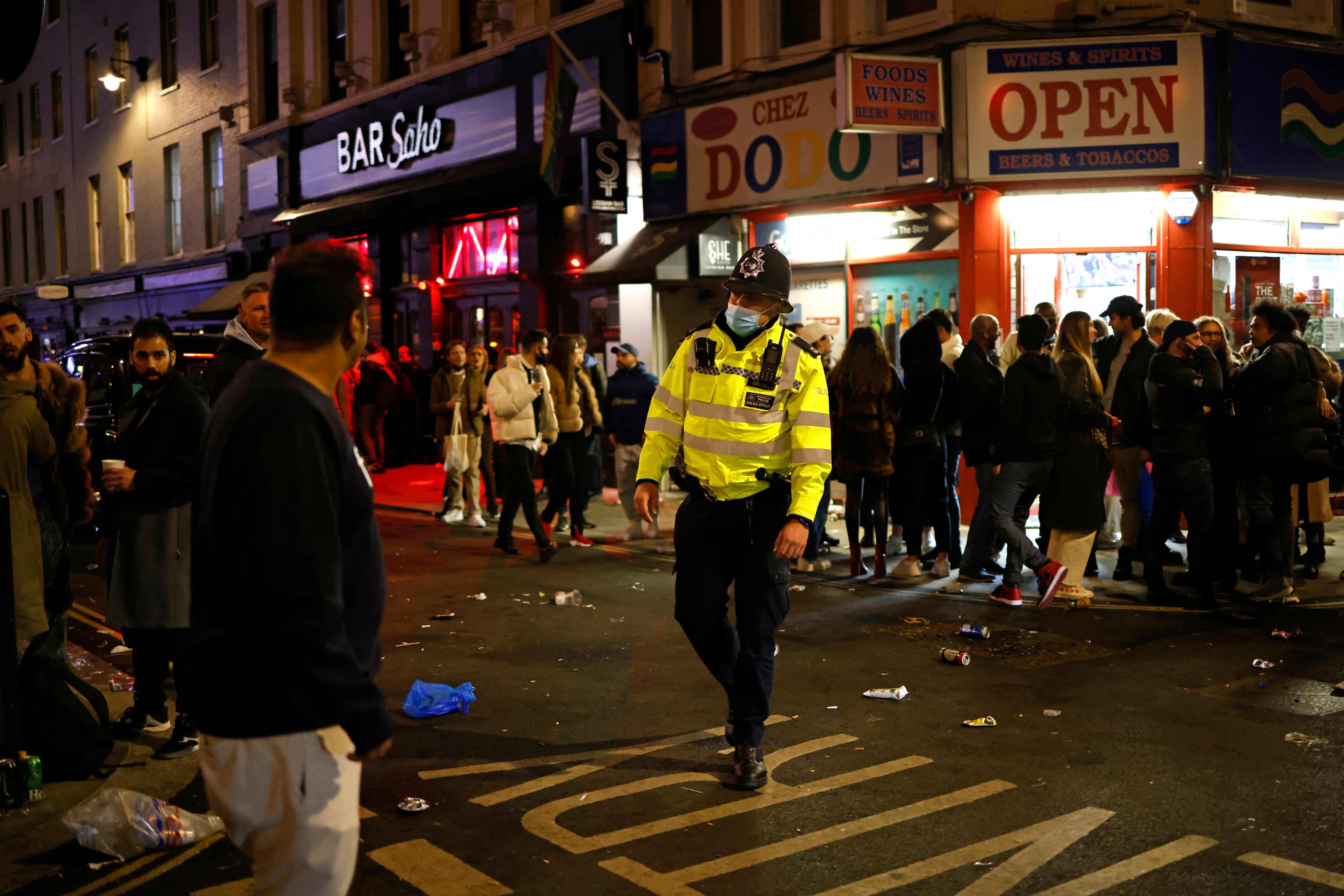 Police patrol the streets in Soho, London on Monday night as pubs reopened after the third lockdown