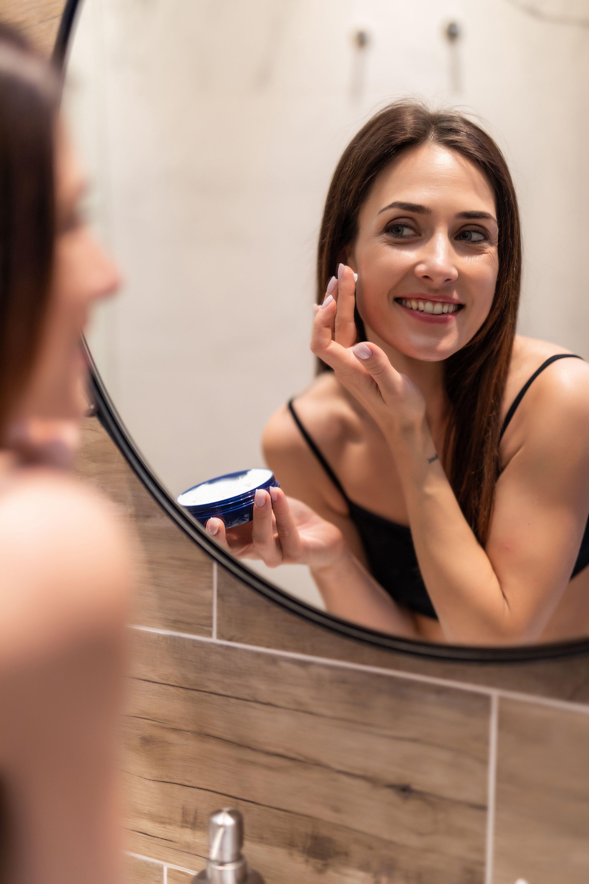 woman looking at mirror at home