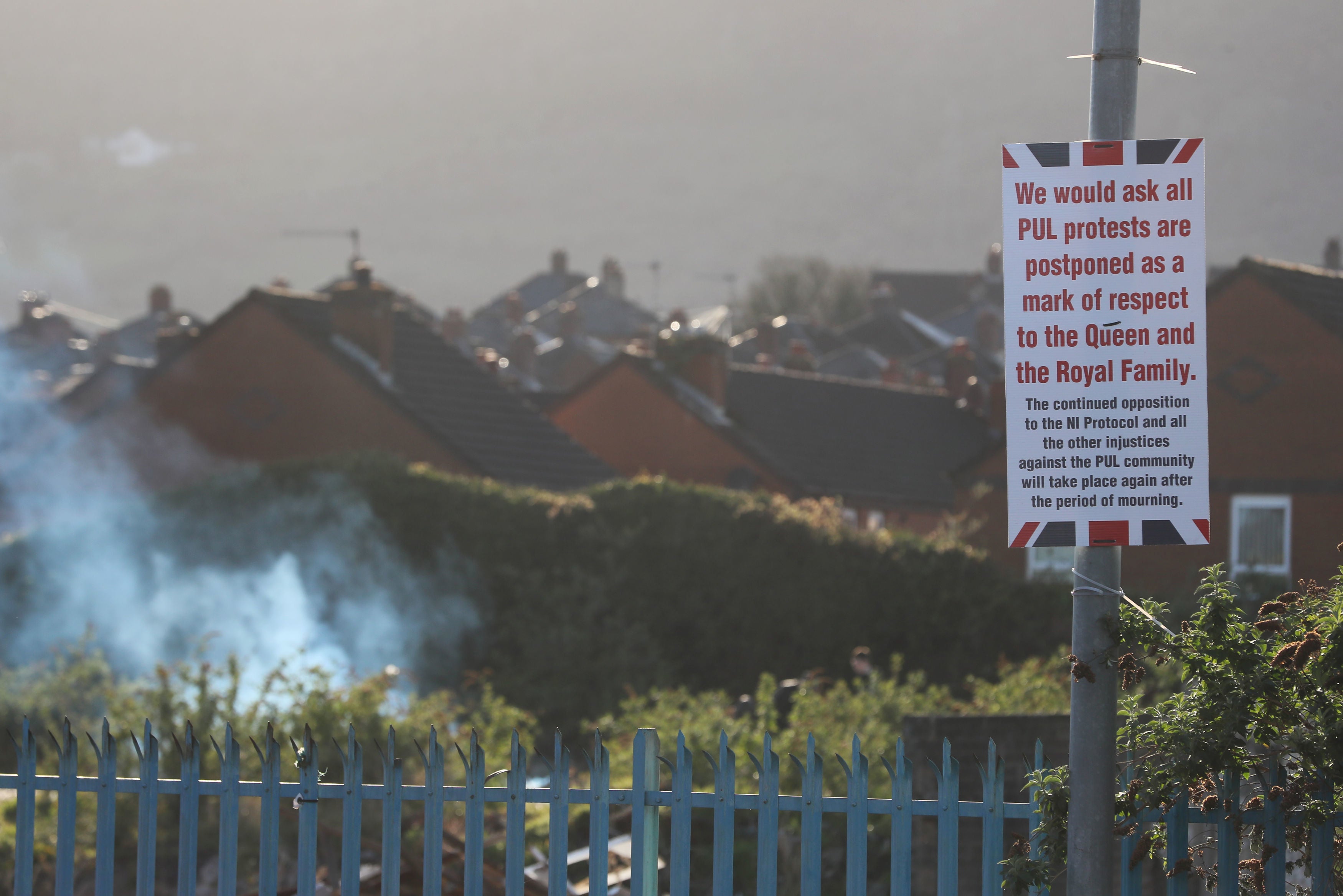 A sign on the corner of the Shankill Road and Lanark Way in Belfast calling for the postponement of protests