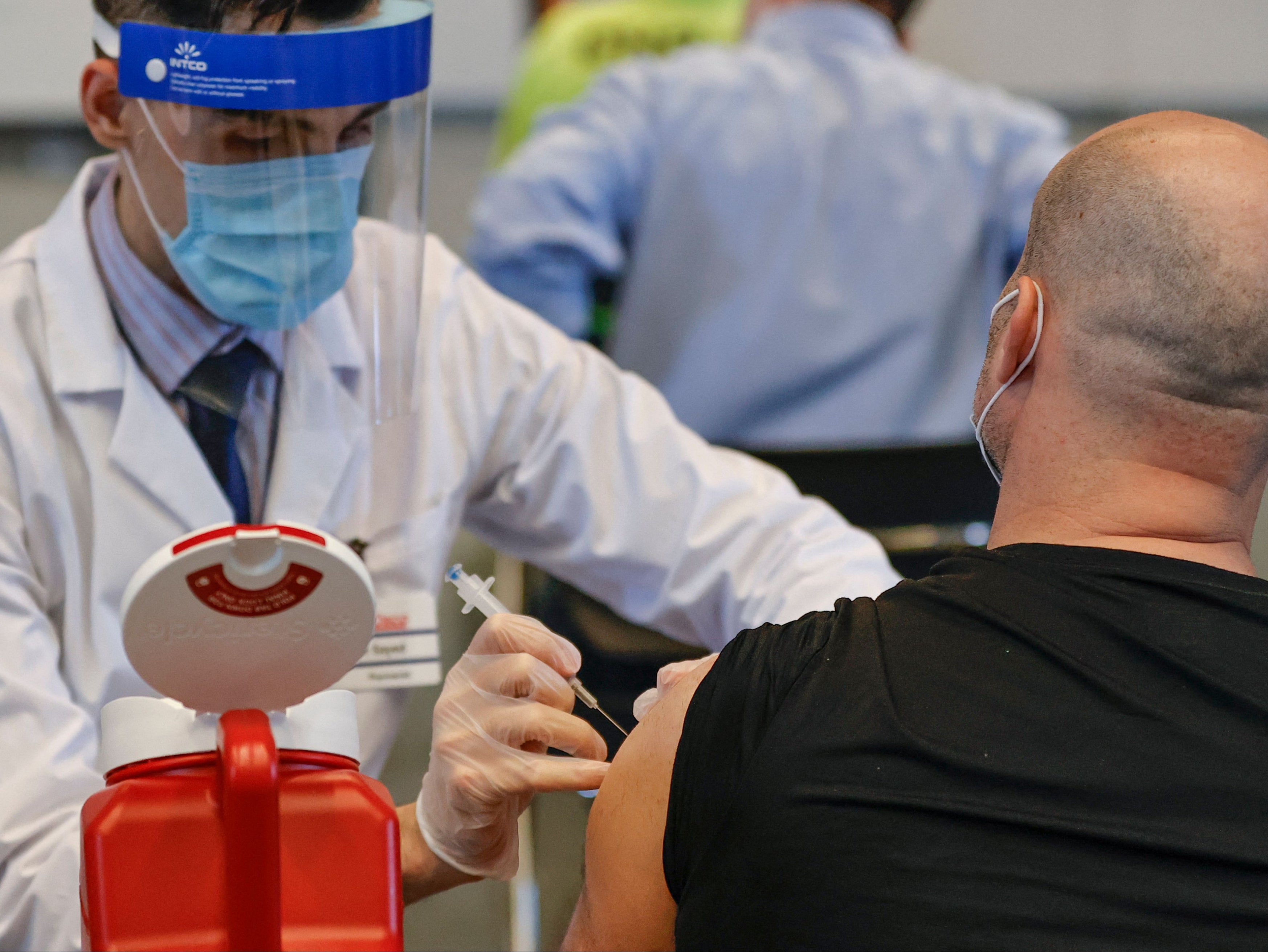 A man receives the Johnson & Johnson vaccine at a vaccination site in Chicago