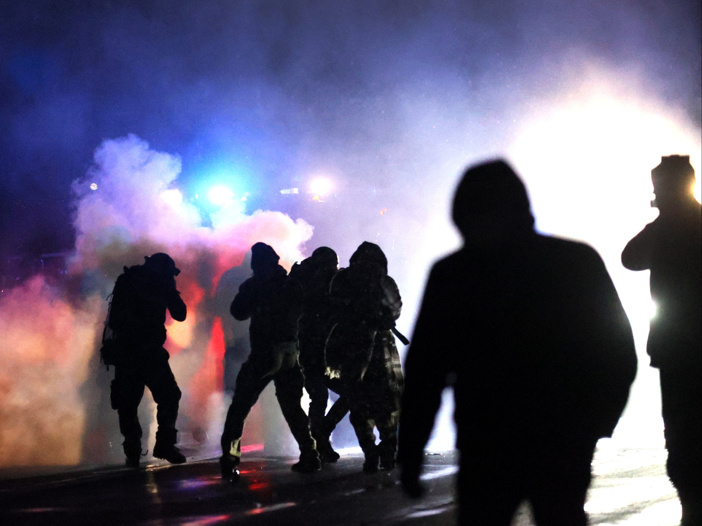 Demonstrators protesting the shooting death of Daunte Wright face off with police near the Brooklyn Center police station on13 April, 2021 in Brooklyn Center, Minnesota