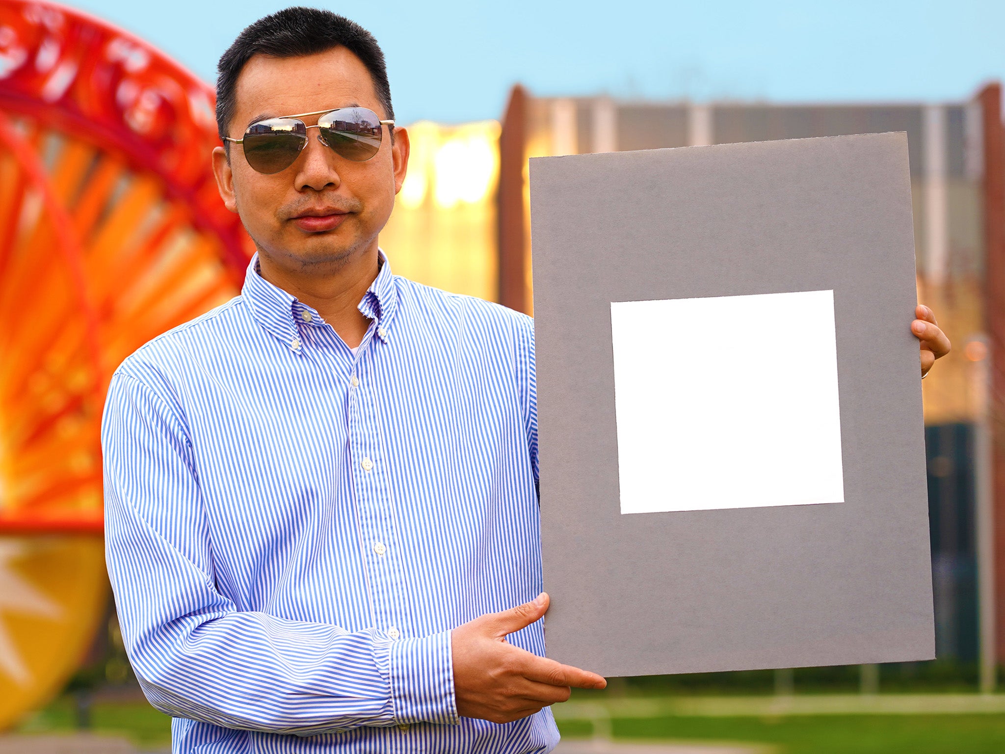 Developer Xiulin Ruan holds up a sample of the ‘whitest paint’