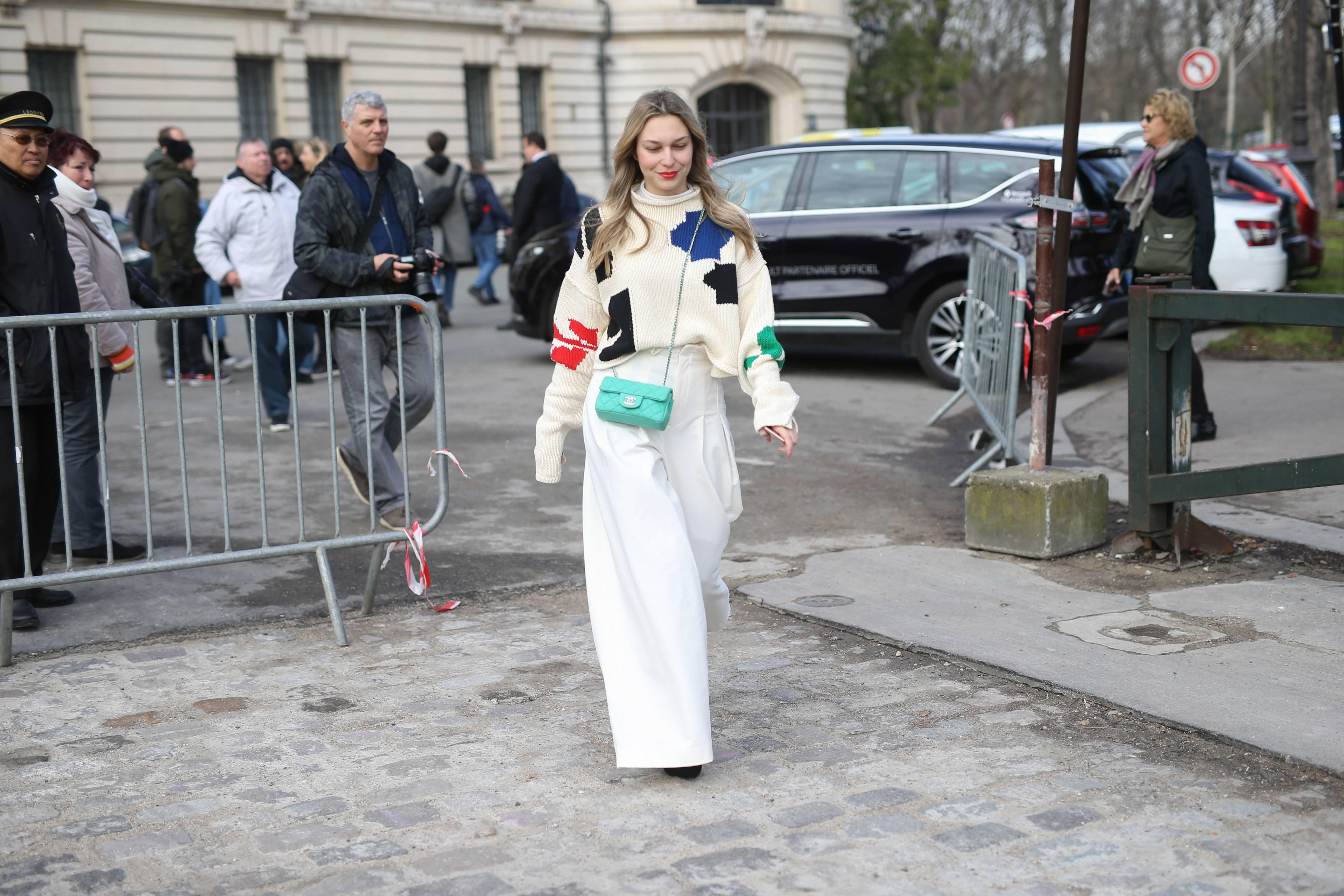 Woman wearing wide legged trousers walking down the street