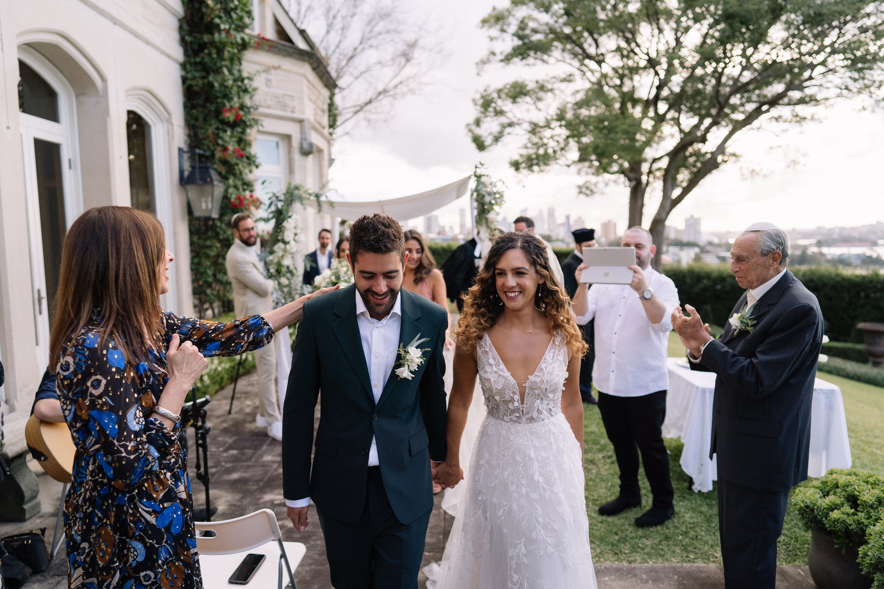 Keren and Jonno, who moved to Australia just three days before the border closed, pictured at their May lockdown wedding in Sydney, with ten in-person attendees and 400 guests on Zoom