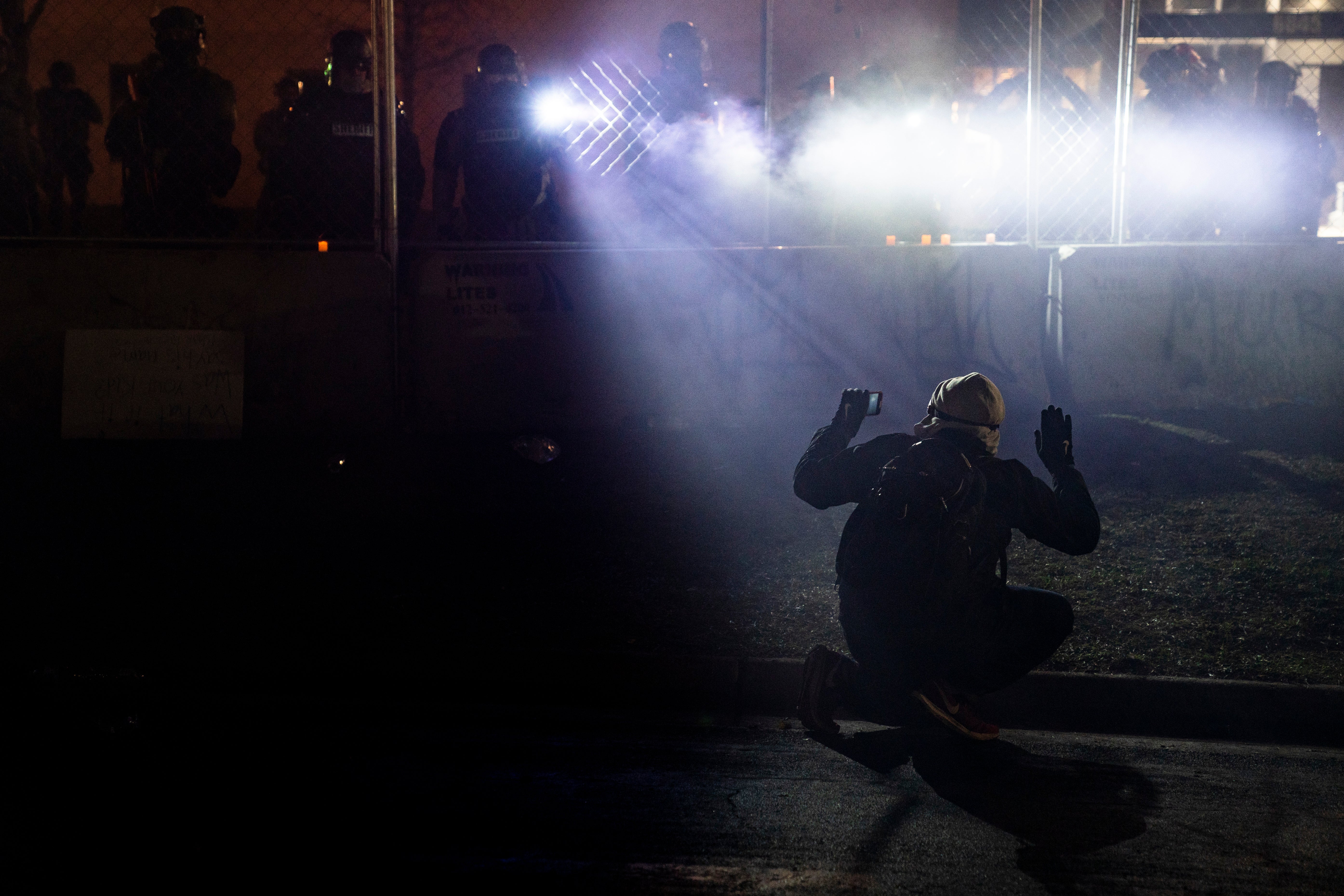 A demonstrator with hands raised outside the Brooklyn Center Police Department in Minneapolis after Sunday’s fatal shooting of Daunte Wright