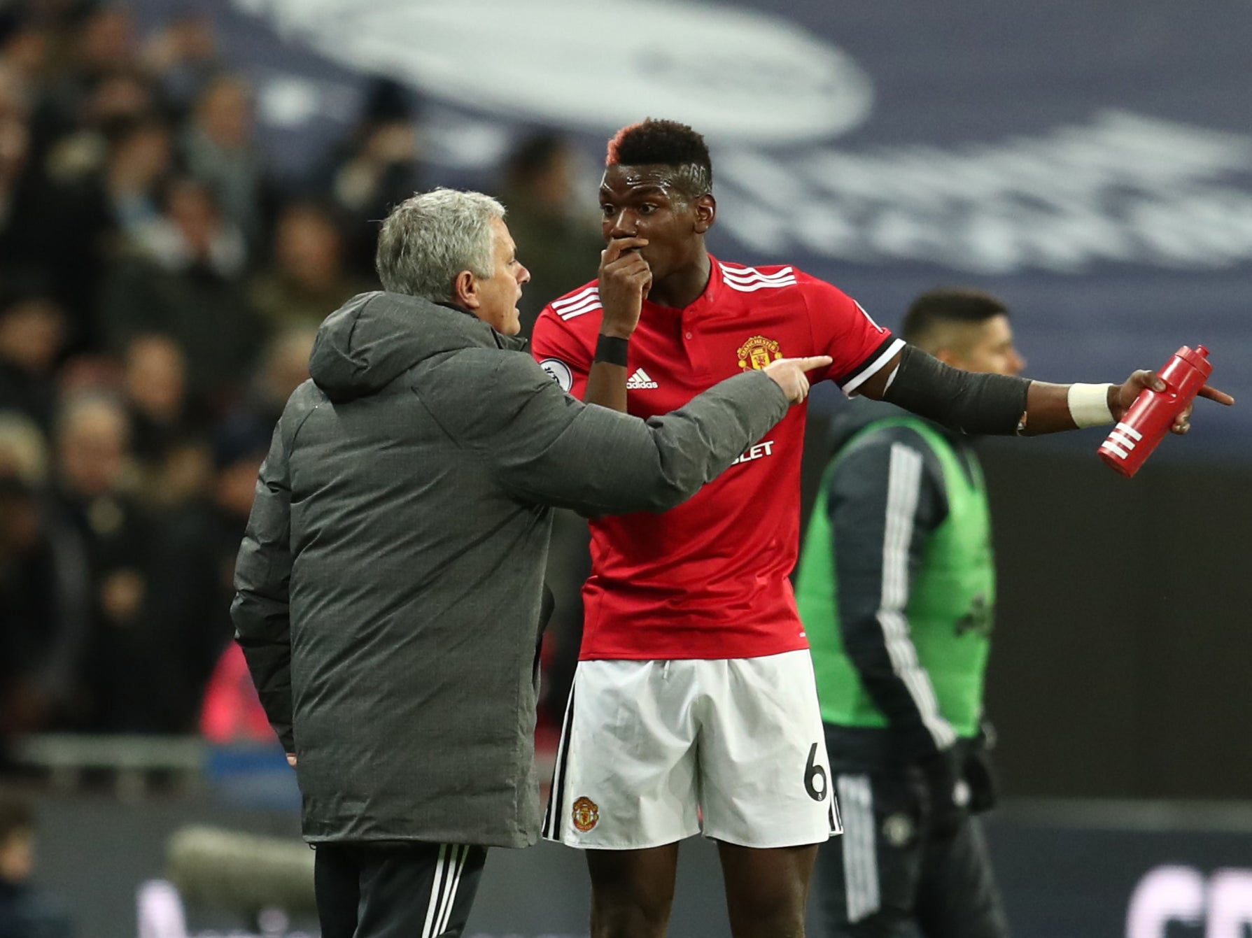 Paul Pogba and Jose Mourinho speak on the touchline in 2018