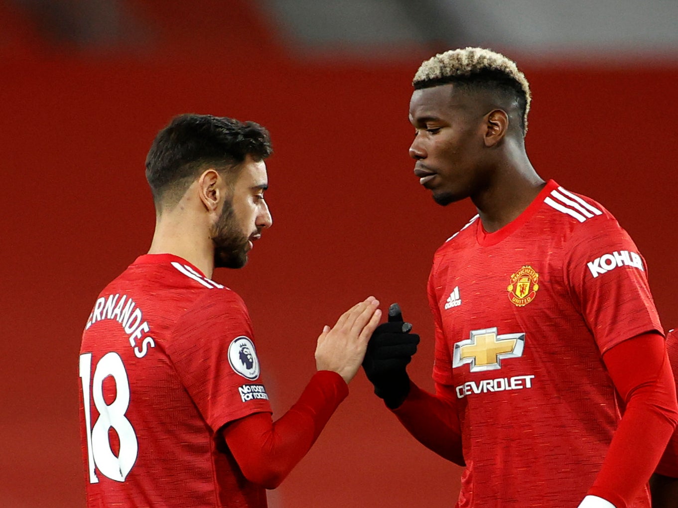 Manchester United team-mates Bruno Fernandes (left) and Paul Pogba