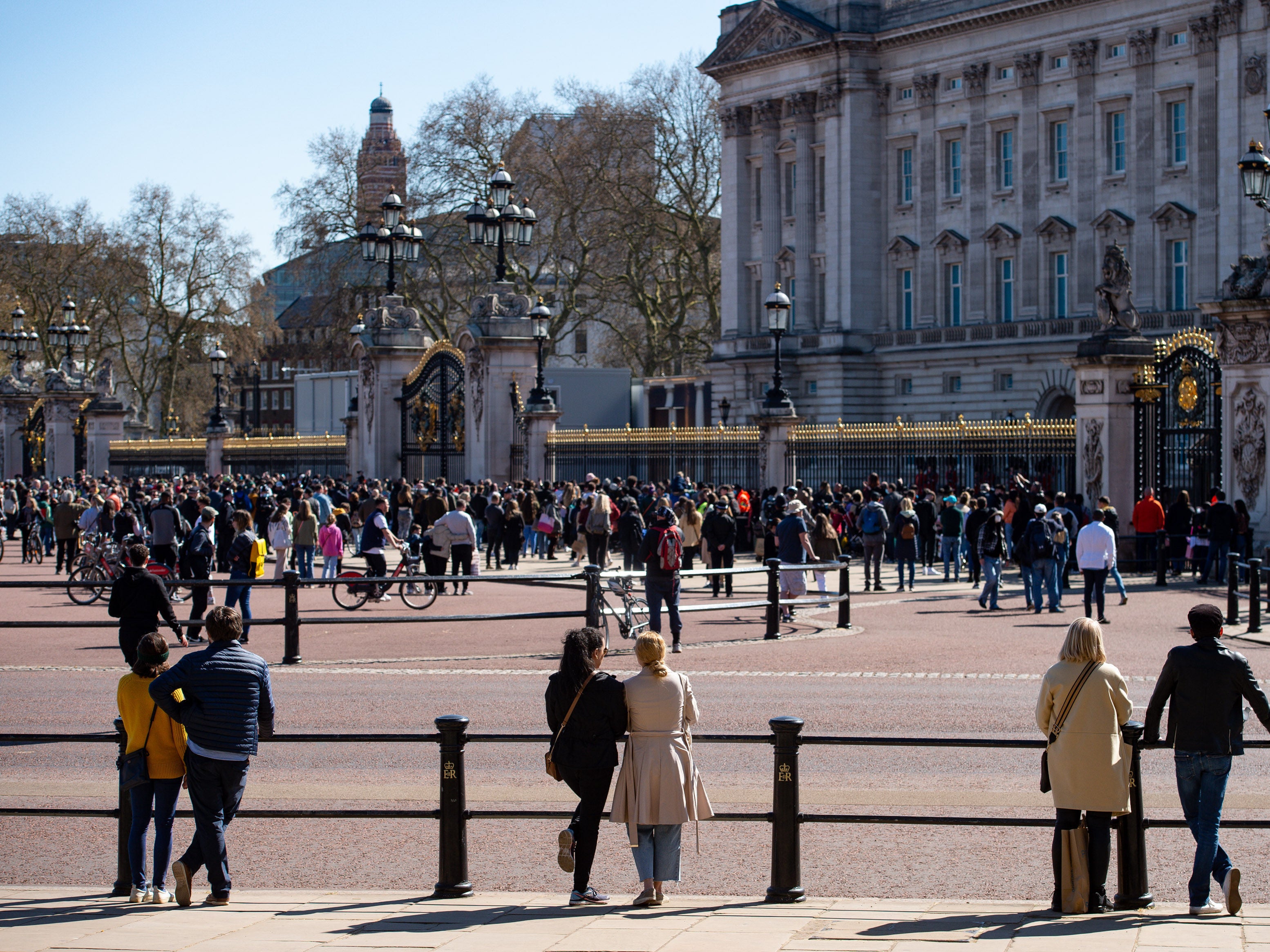 People observe a minute's silence outside Buckingham Palace, London