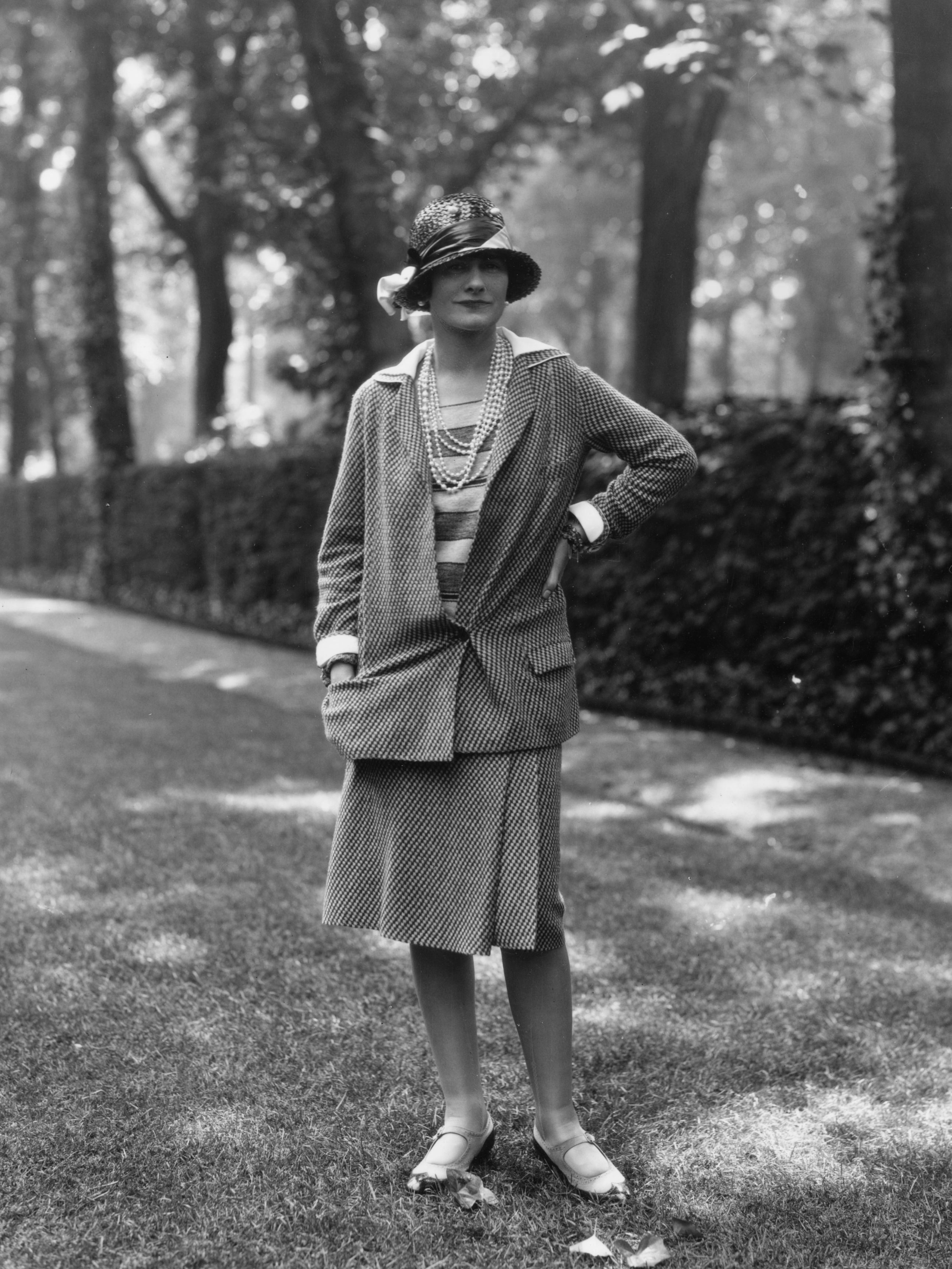 Coco Chanel modelling a Chanel suit at Fauborg, St Honore, Paris in 1929.