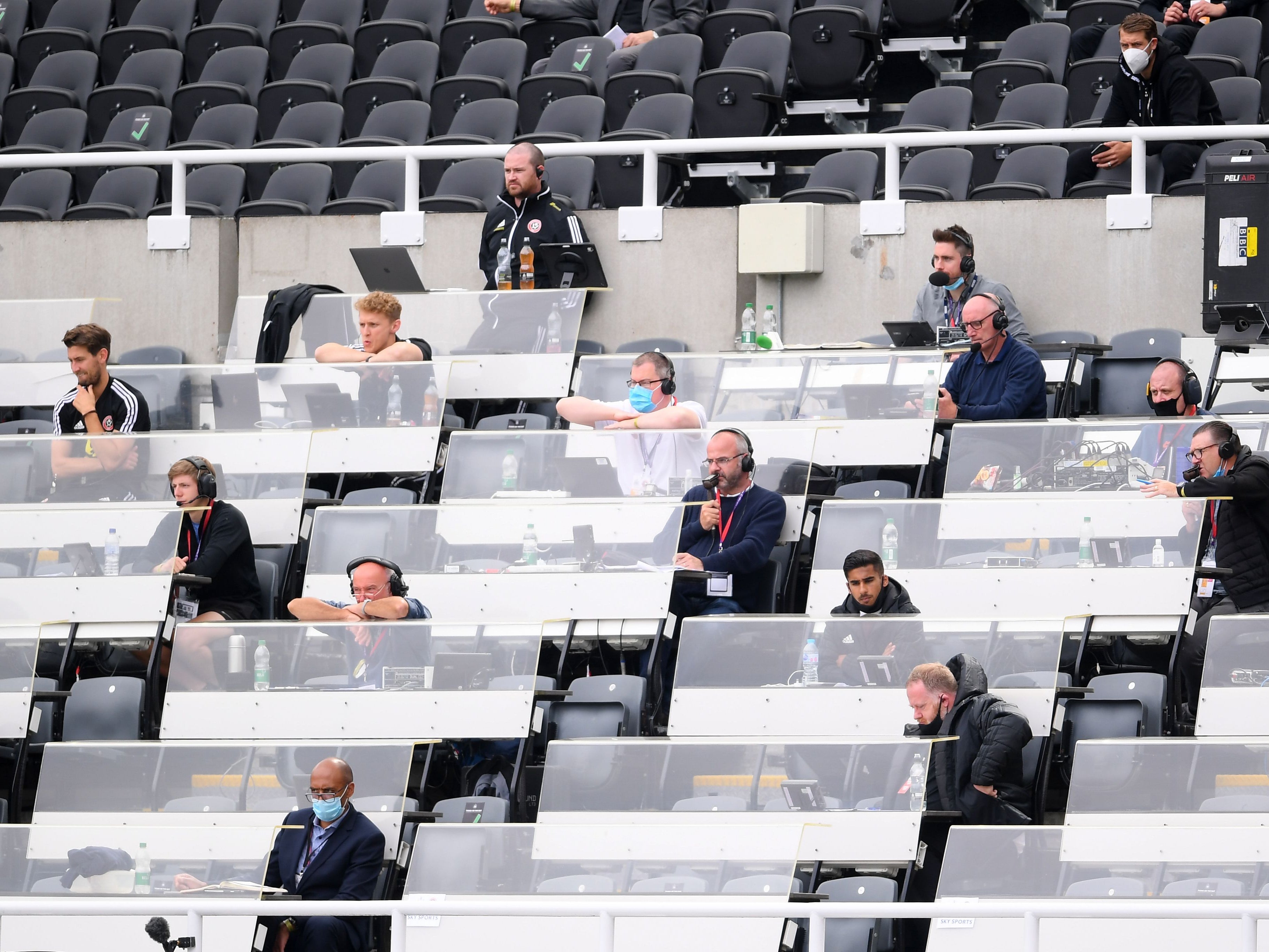 Journalists watch on from a press box