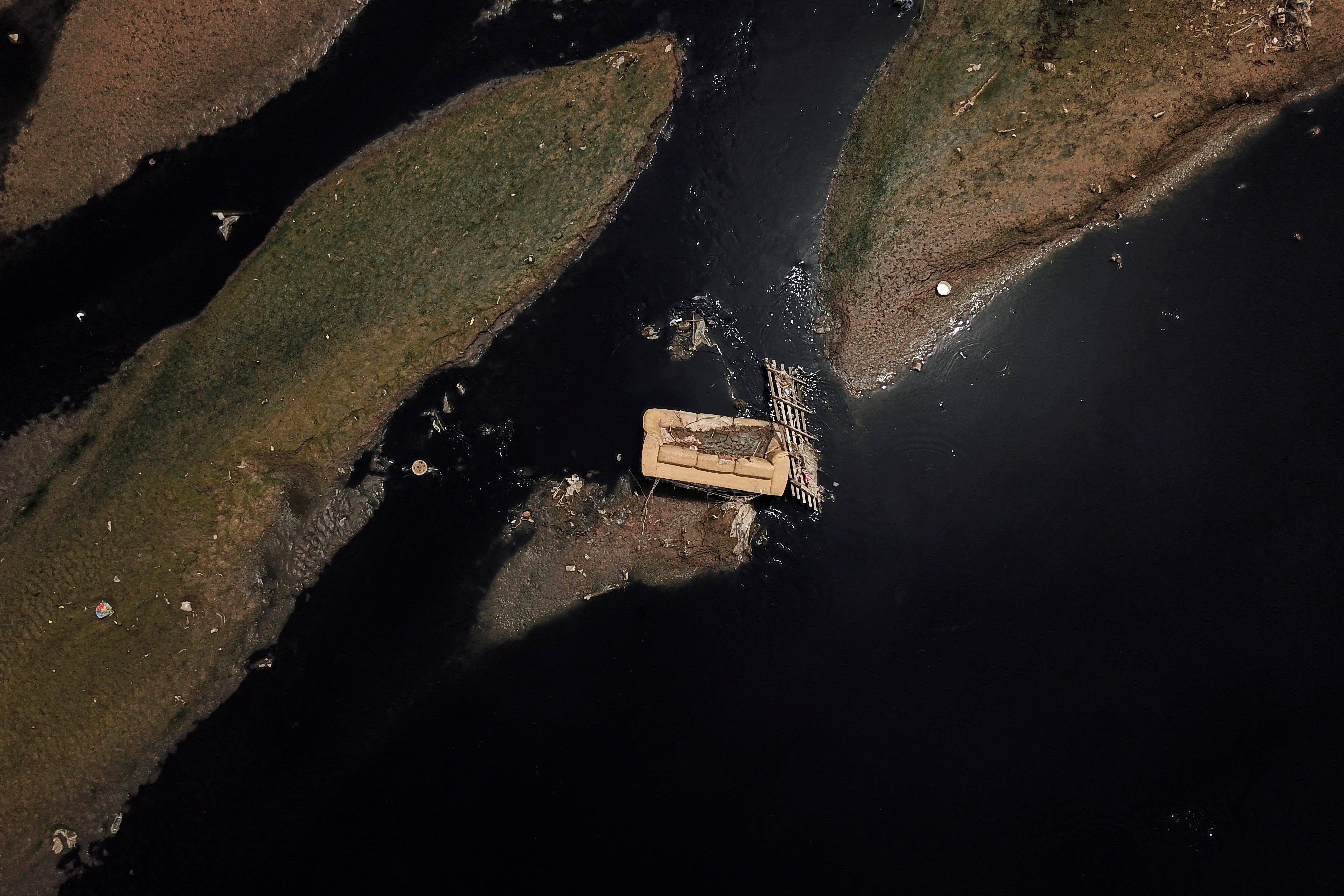 A discarded sofa on the Tiete river near Ecological Tiete Park in Sao Paulo, Brazil