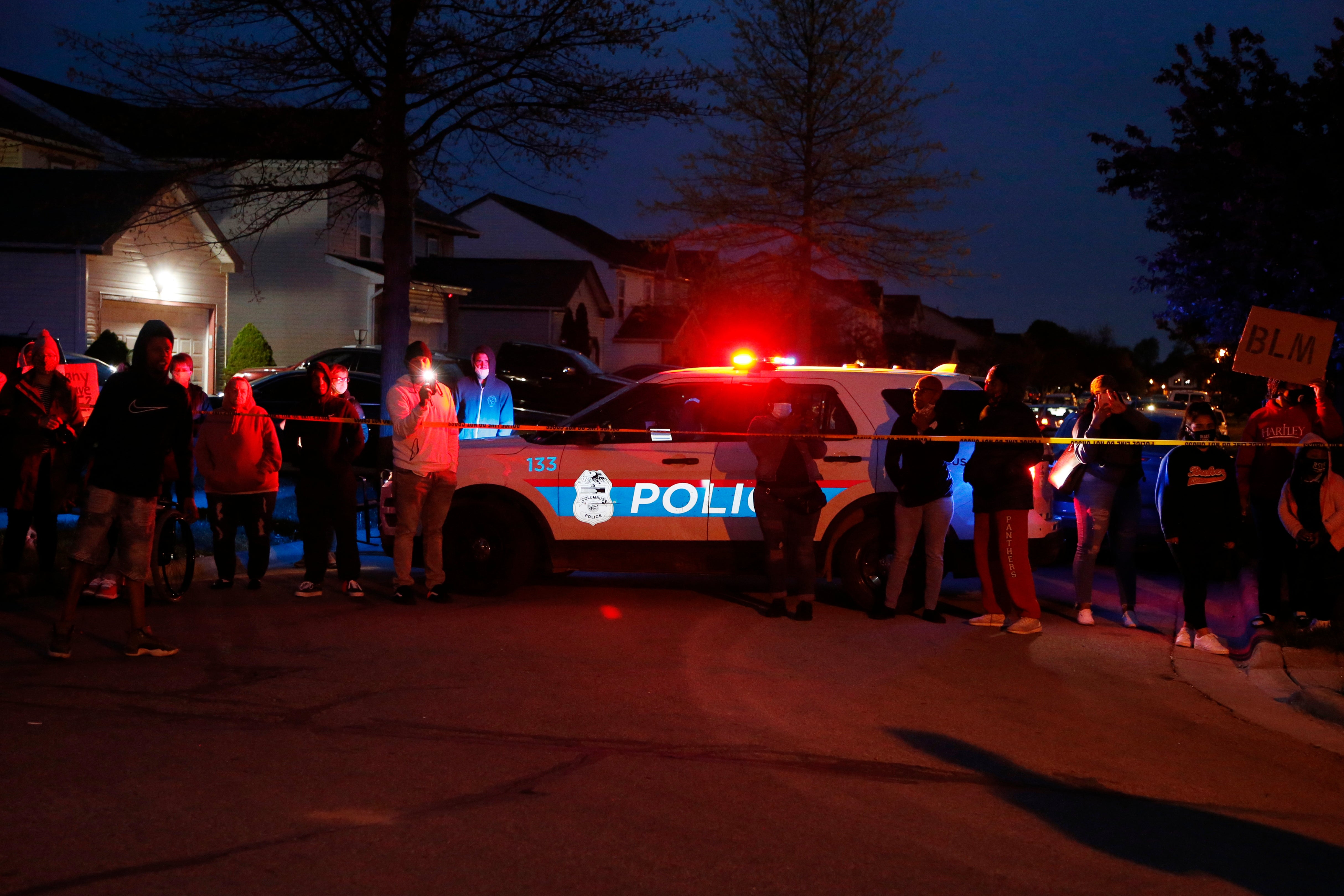 A crowd gathers to protest in the neighbourhood where a Columbus police officer fatally shot a teenage girl on Tuesday