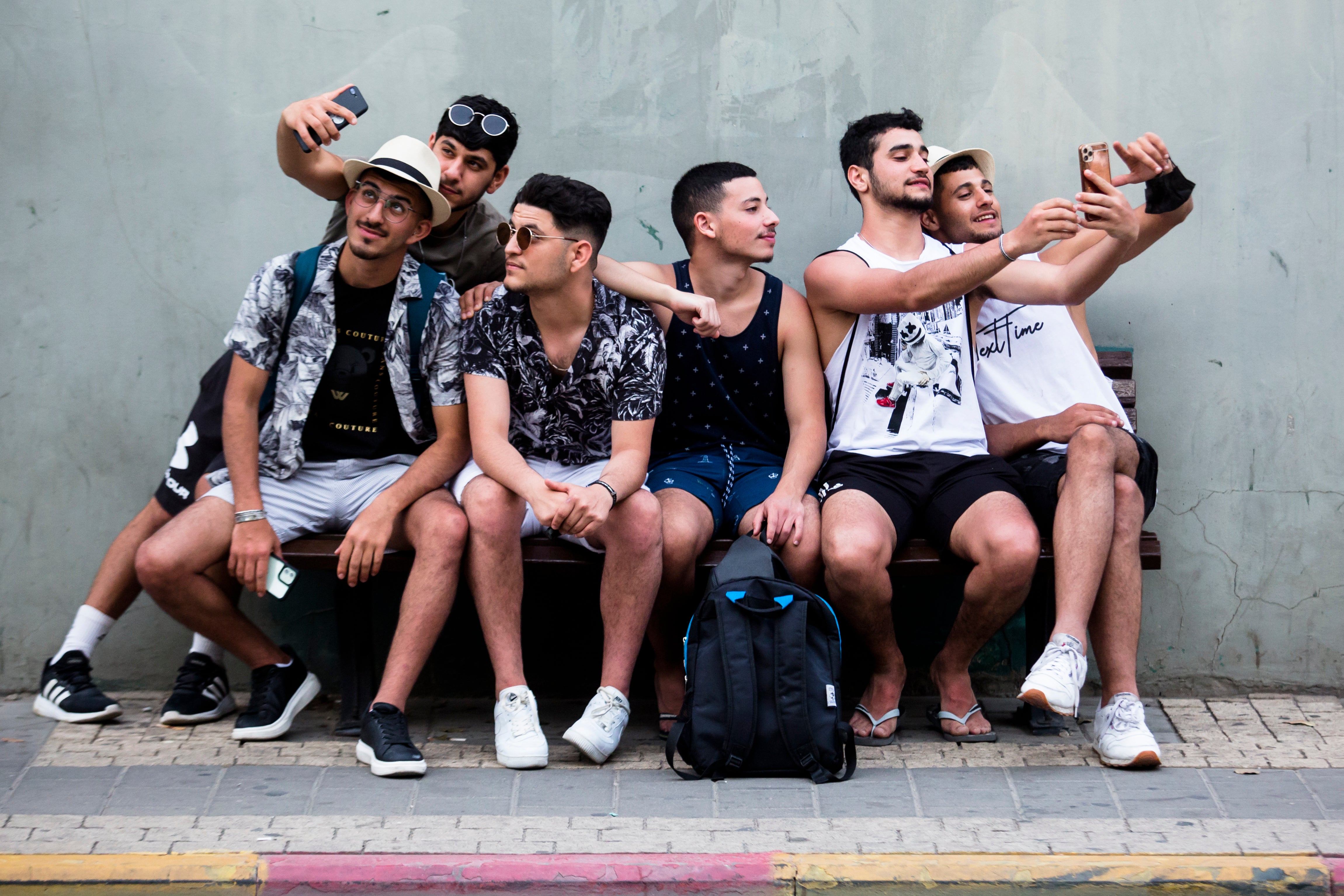 Israelis take a photo as they are sitting in a street with no face mask on April 19, 2021 in Tel Aviv, Israel. As of April 18, Israelis could circulate outdoors without a face mask, for the first time in a year.