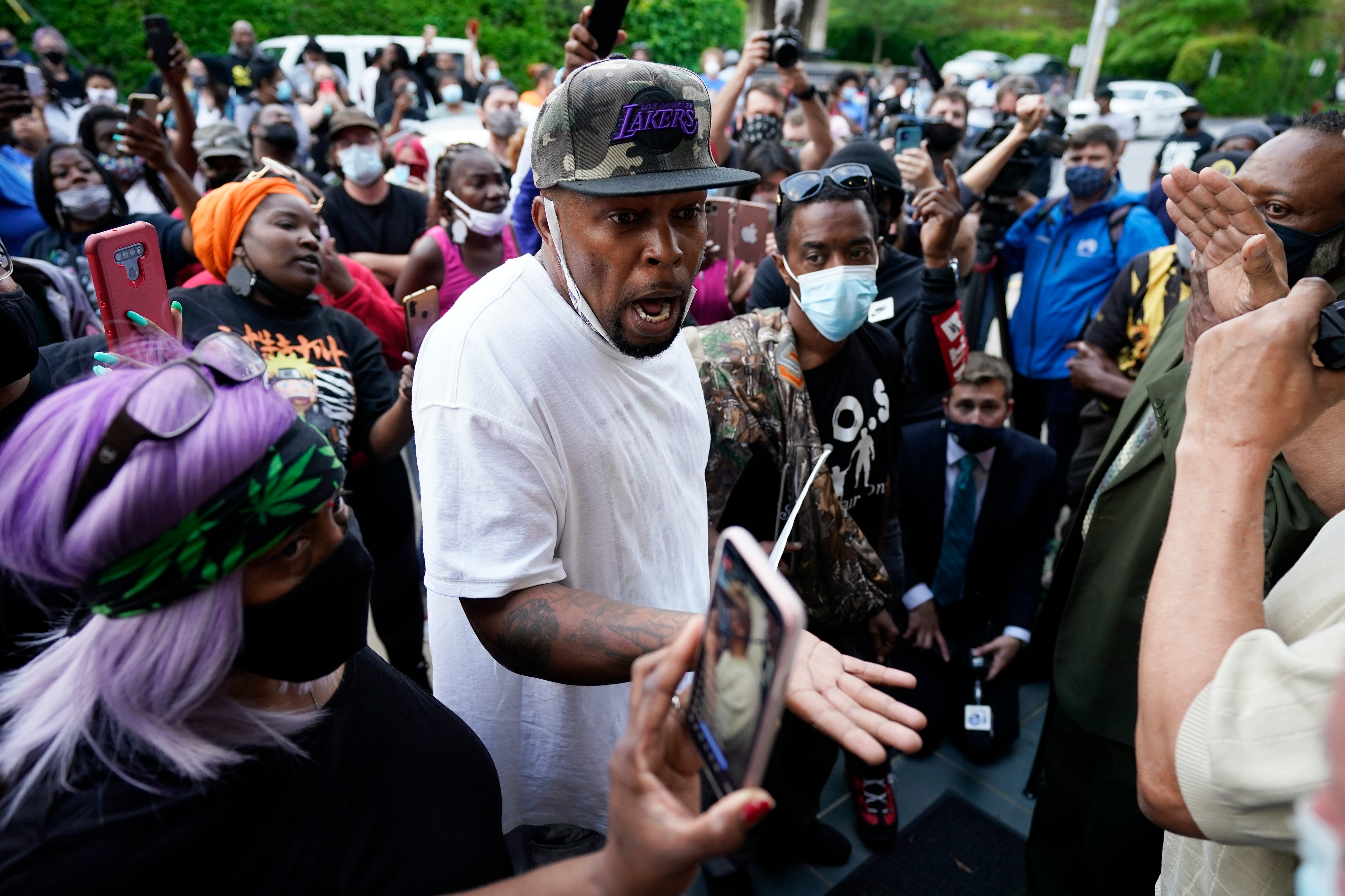 People gather outside the municipal building after Andrew Brown was killed