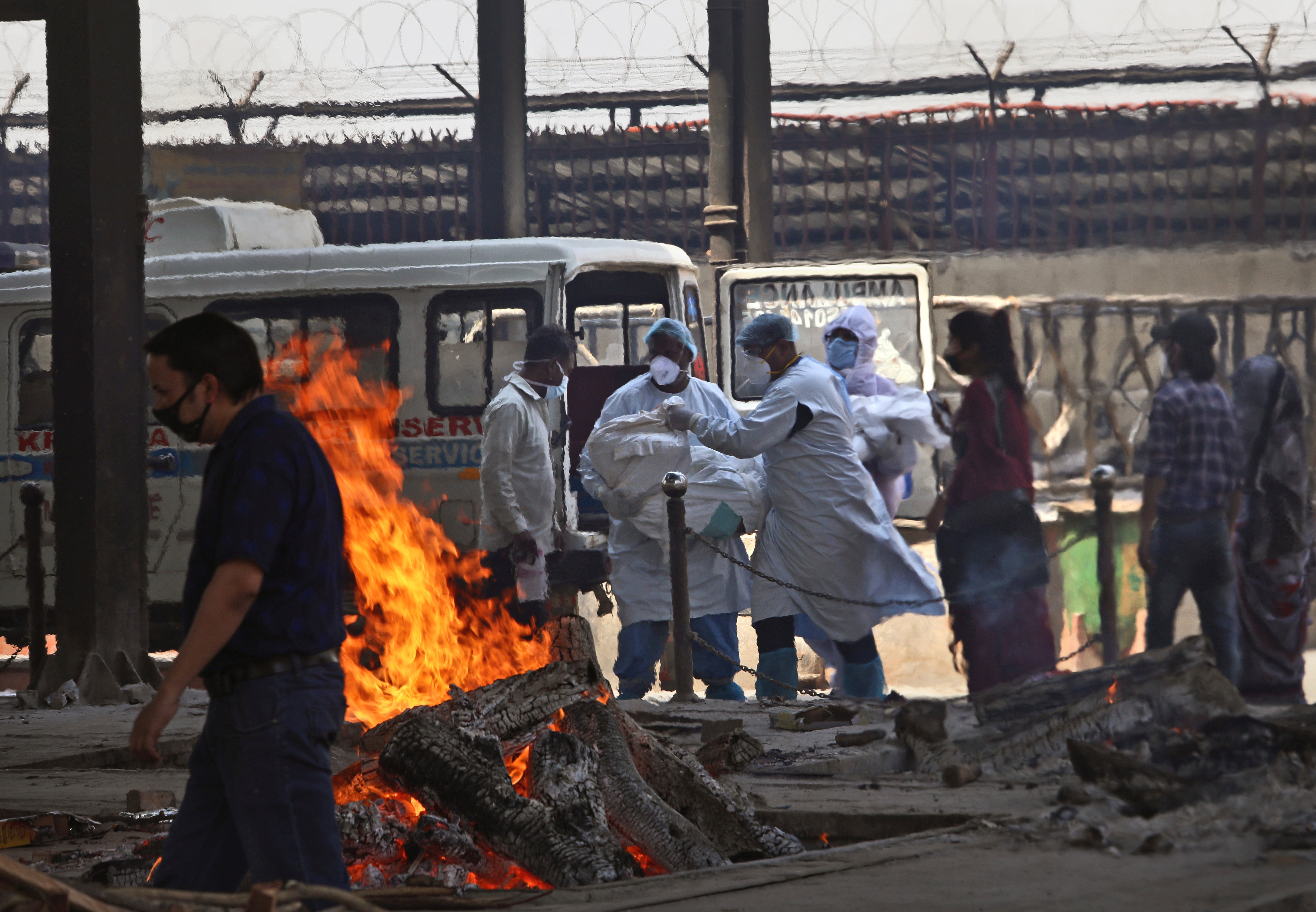 Health workers carry the body of a Covid-19 victim for cremation, in New Delhi, India, on 19 April