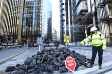 Extinction Rebellion activists dump fake coal outside Lloyd’s of London in fossil fuel protest