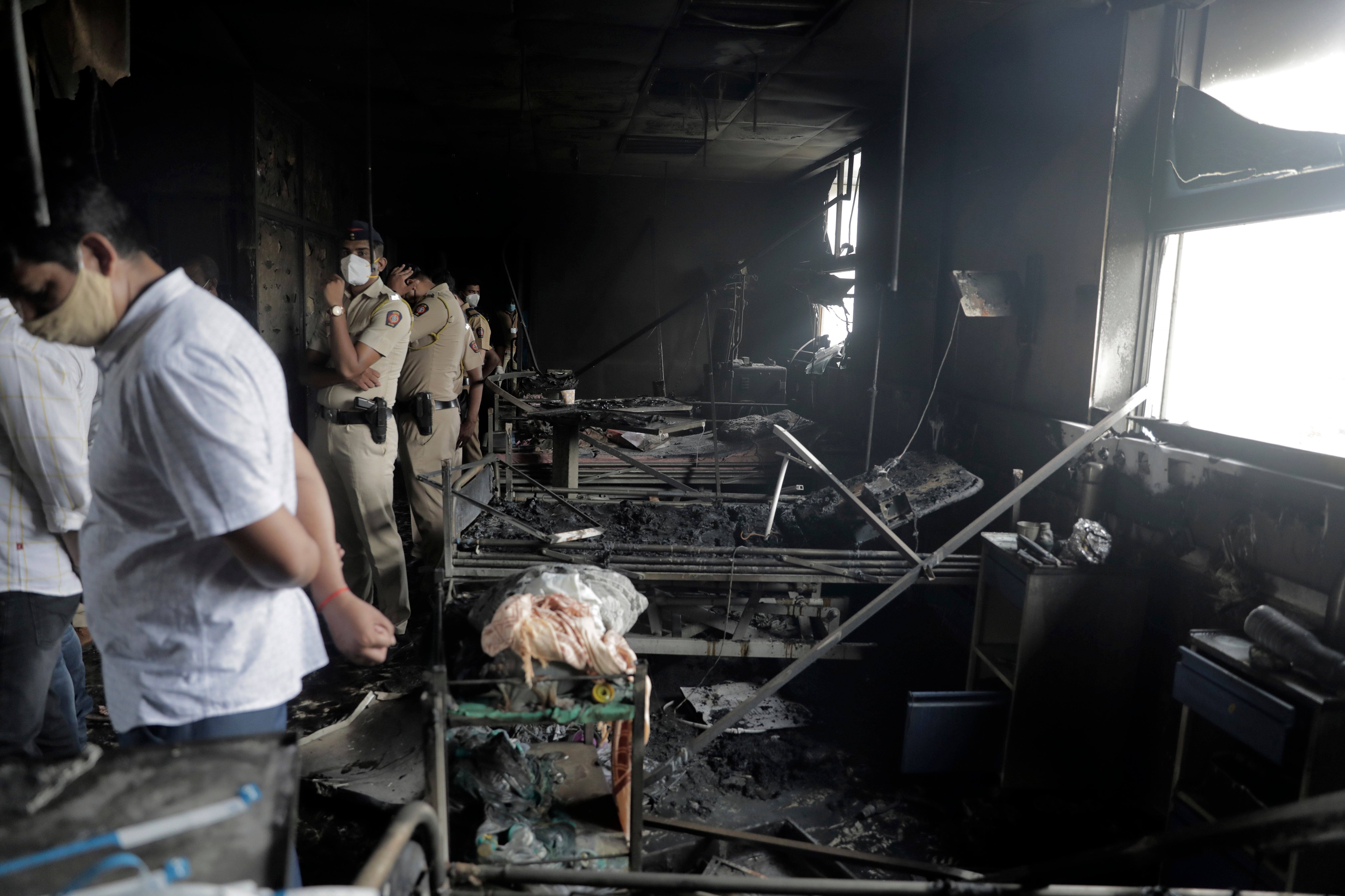 People inspect an ICU ward after a fire broke out in Vijay Vallabh COVID-19 hospital at Virar, near Mumbai