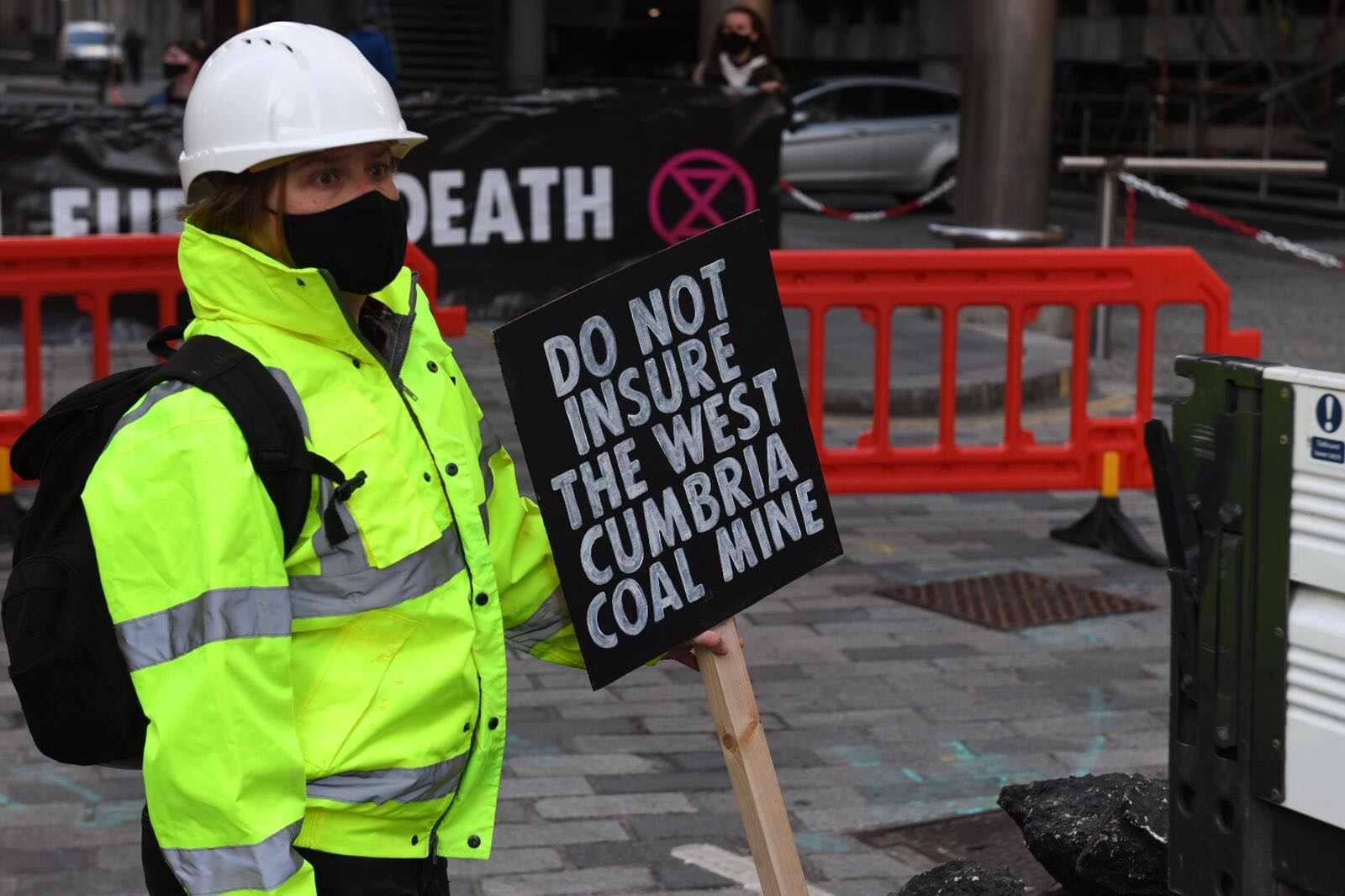 A sign placed in a fake mound of coal reads ‘do not insure the west Cumbria coal mine