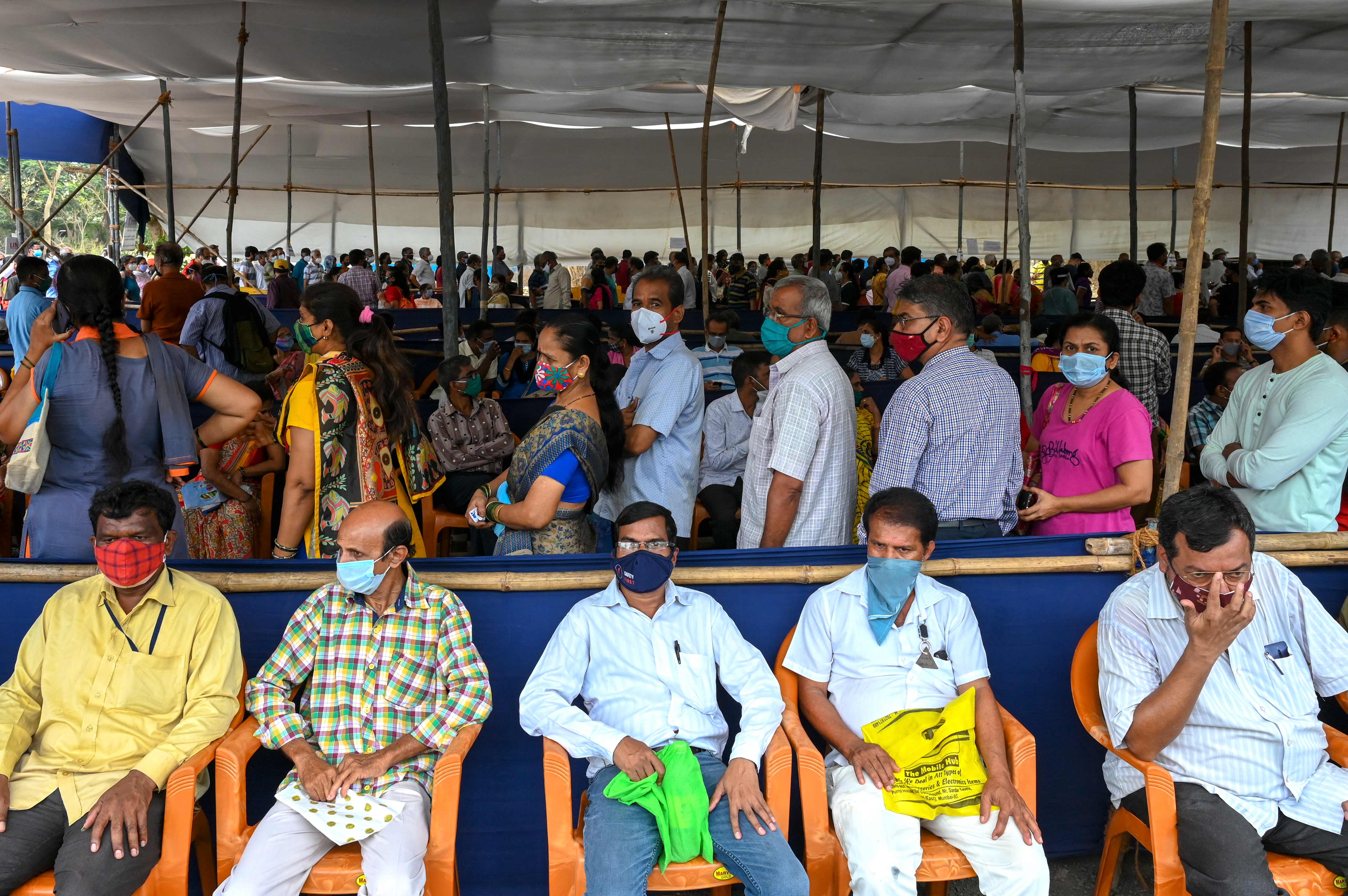 People wait in a queue to receive the Covid-19 coronavirus vaccine at a vaccination centre in Mumbai earlier this month